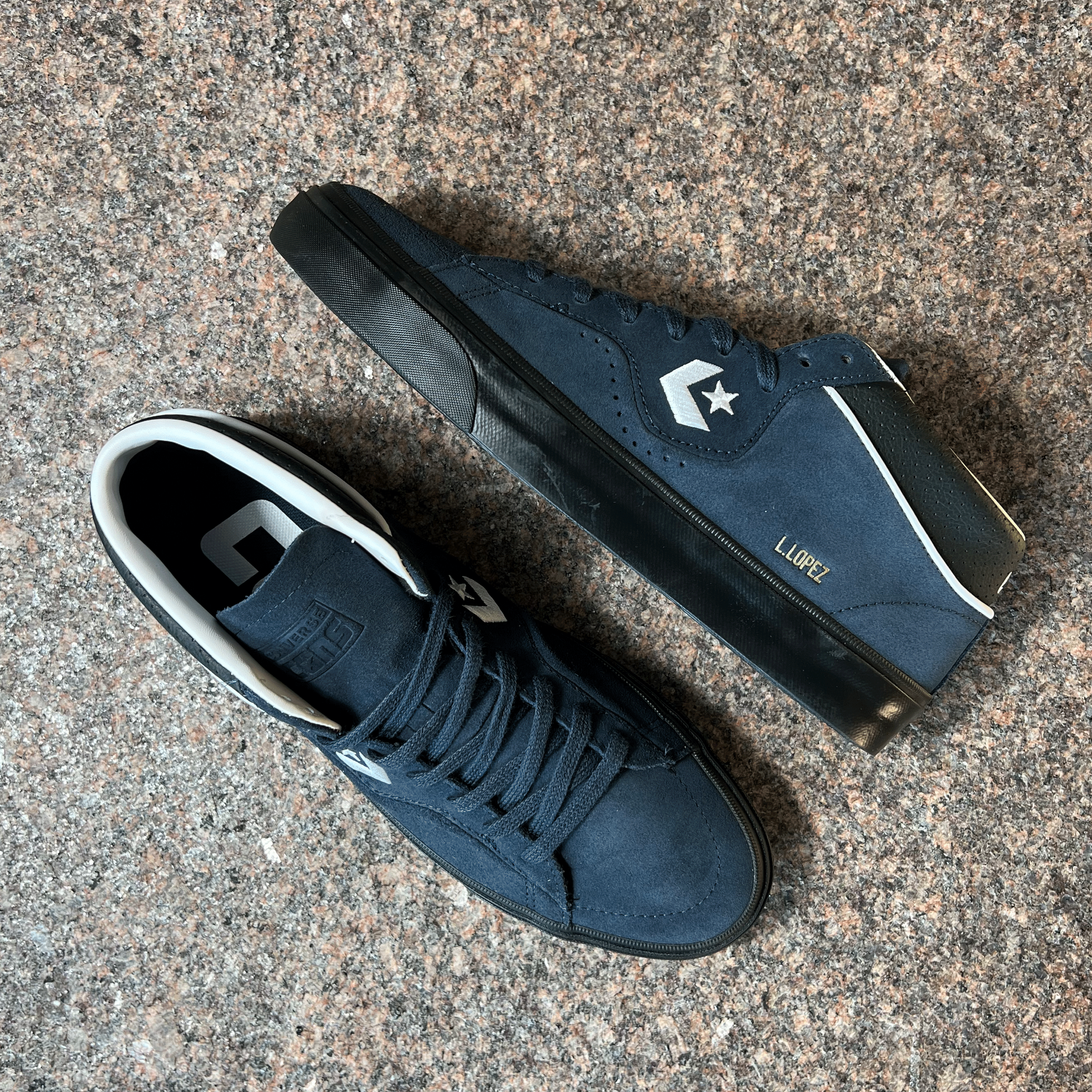 CONVERSE CONS LOUIE LOPEZ PRO MODEL SHOES IN DARK BLUE AND BLACK SOLE DISPLAYED ON GRANITE