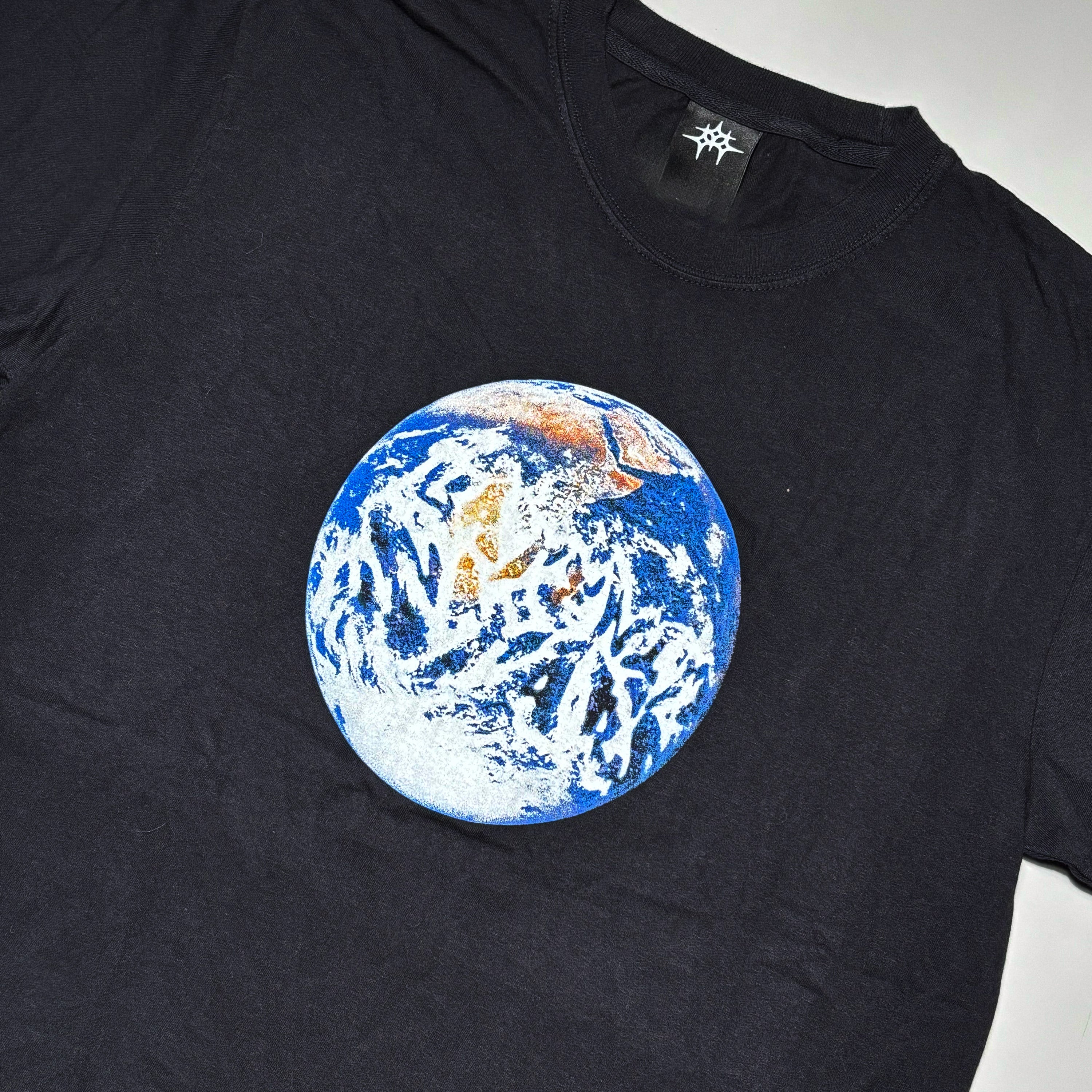 Close detail of world printed art on chest.