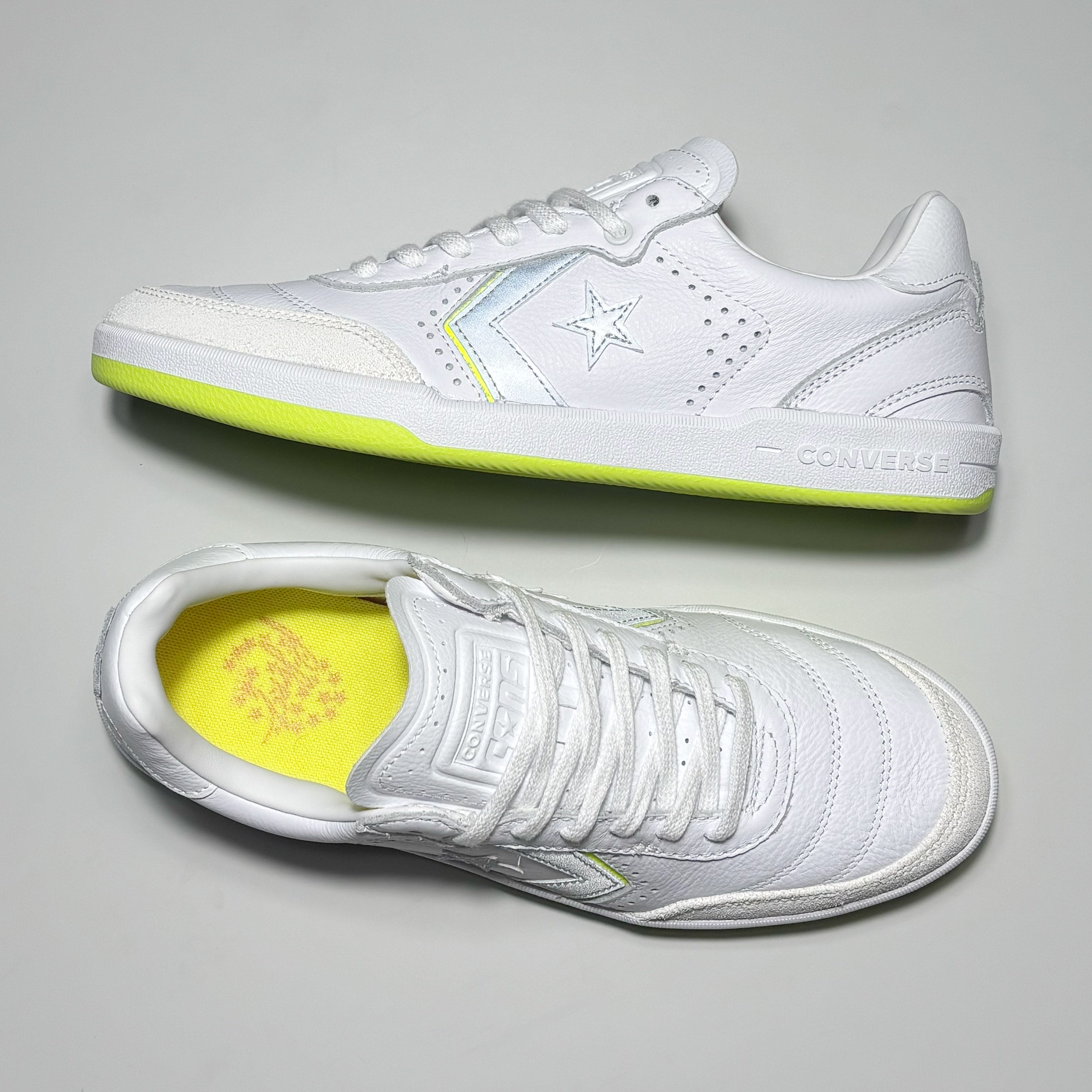 Close detail of 3M reflective branding and embossed Converse logo on tongue. 