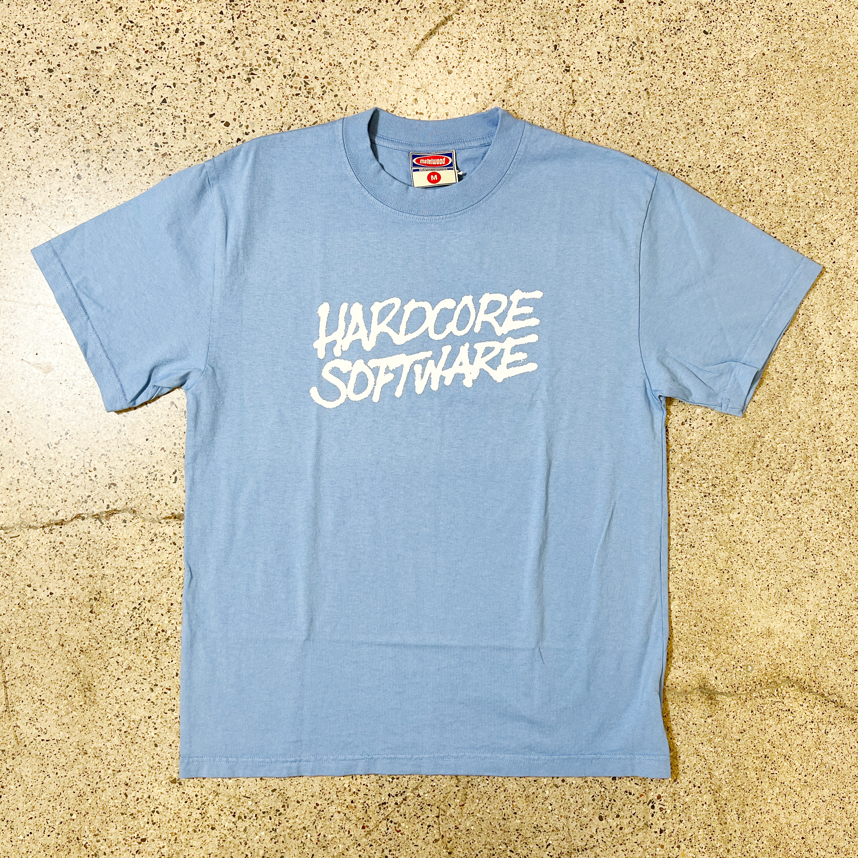 LIGHT BLUE METALWOOD T-SHIRT WHITE FONT THAT READS HARDCORE SOFTWARE CENTER CHEST