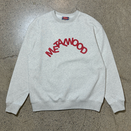 Full image of oatmeal color fleece crewneck with red metalwood letters on chest