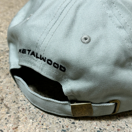 Back image of strapback closure with metalwood embroidered on back of hat