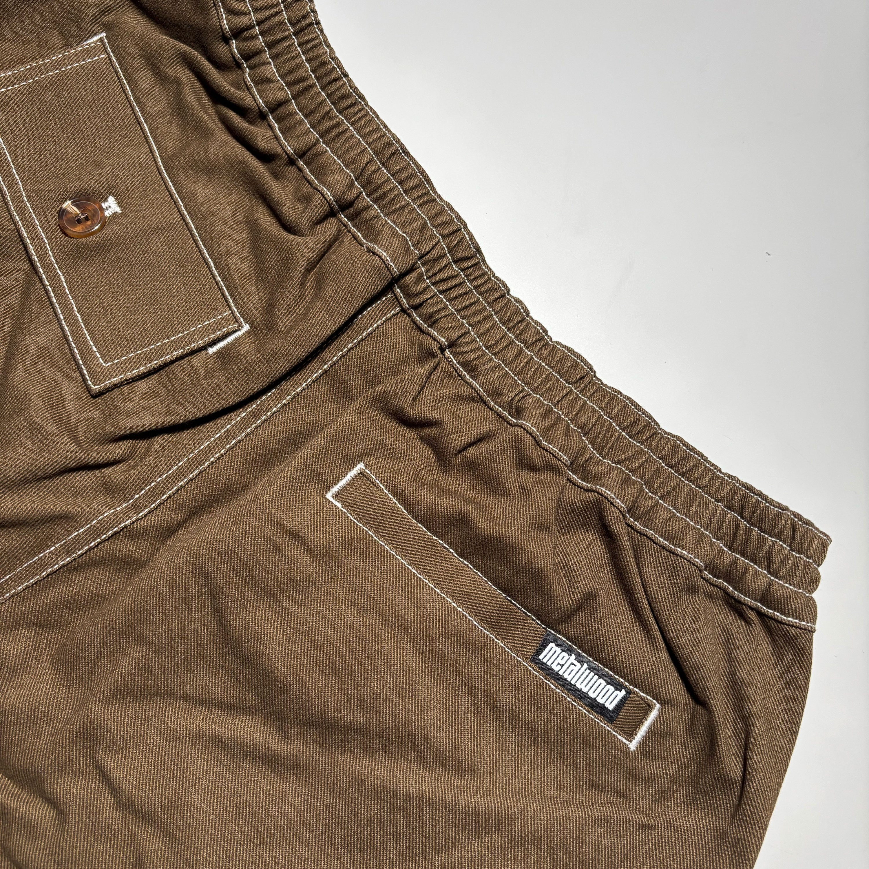 Back detail of elastic waist and pocket detail with woven label on pocket
