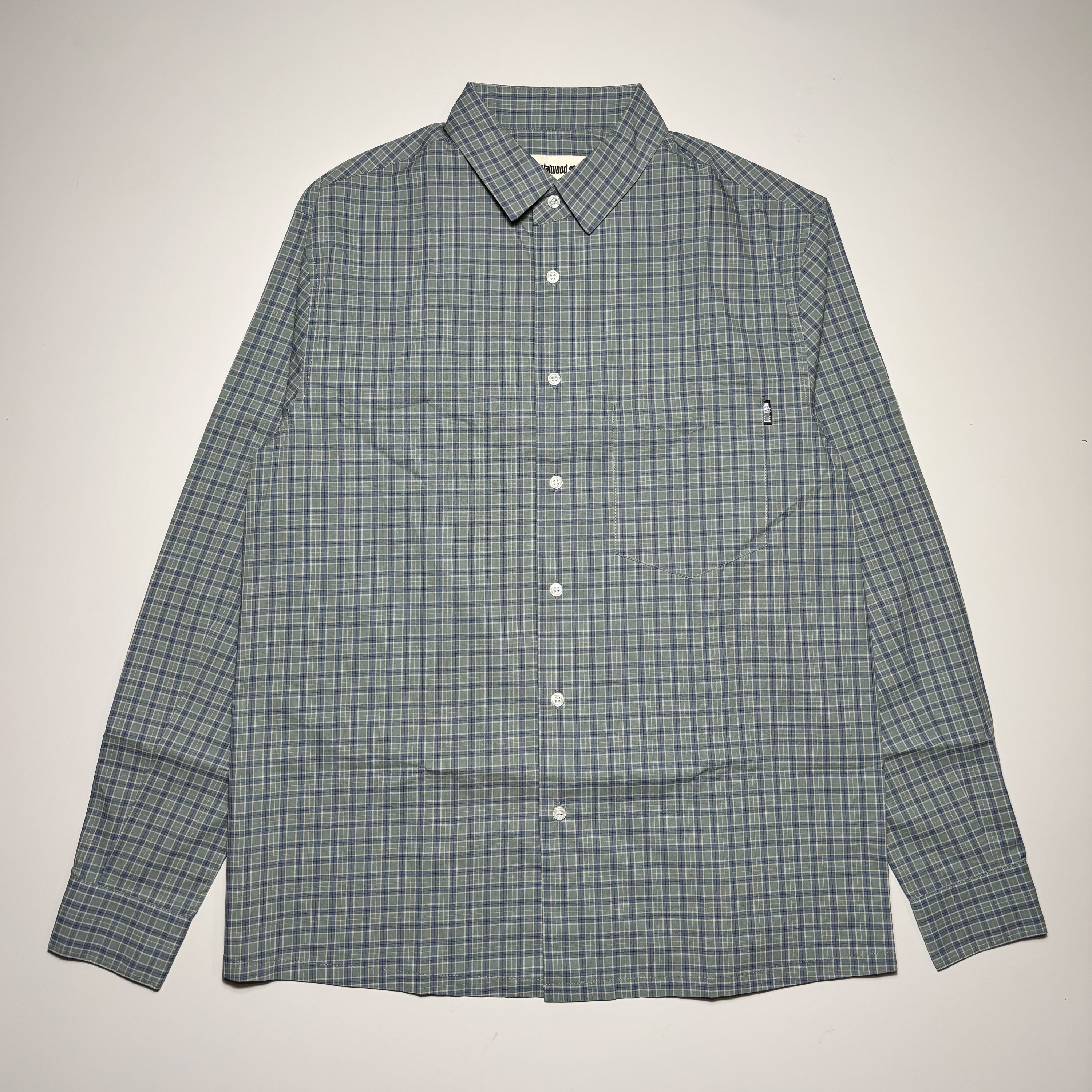 Front image of pine green checker plaid button up. 