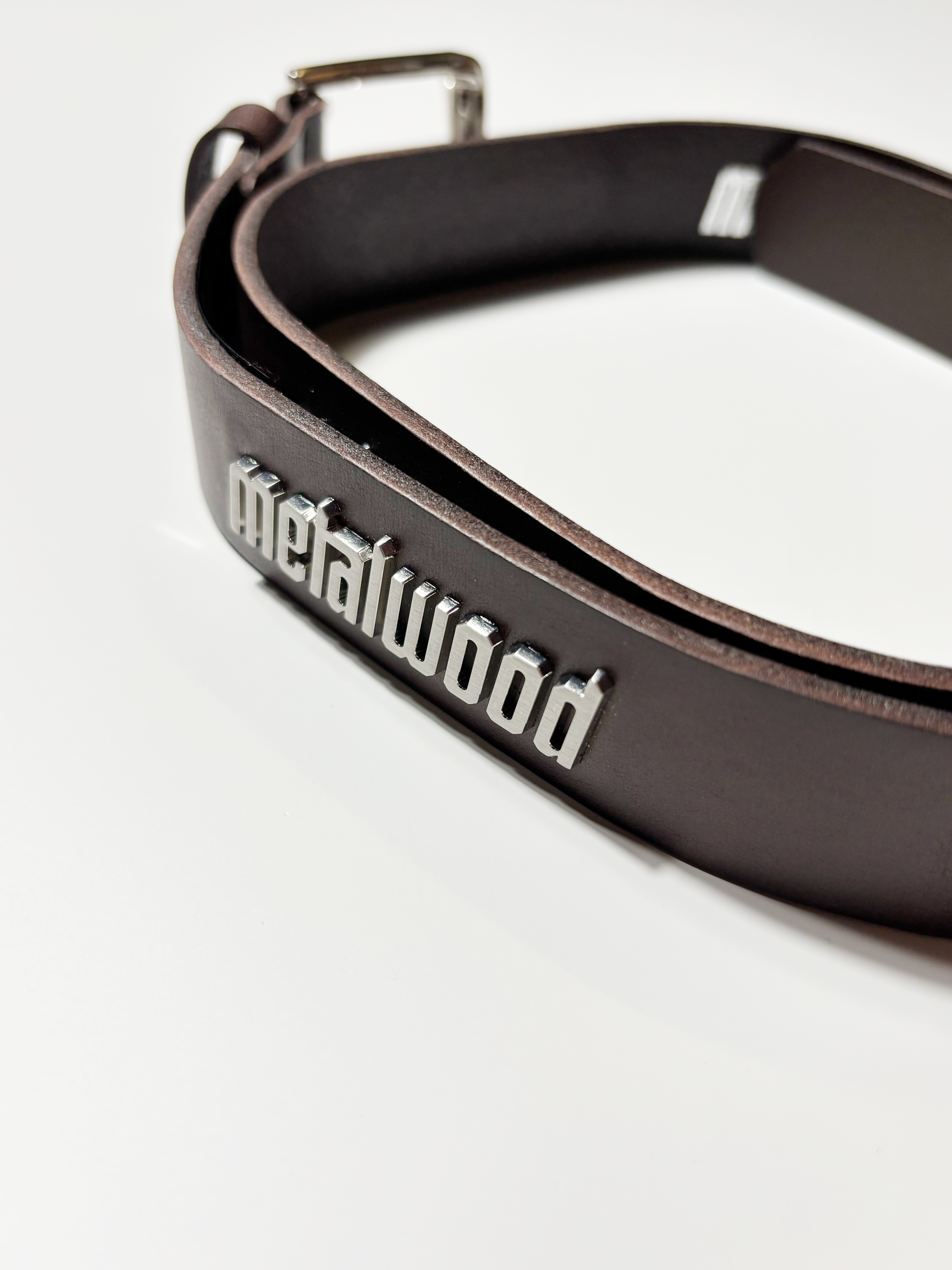 Close detail of metalwood metal stud on outside of belt.