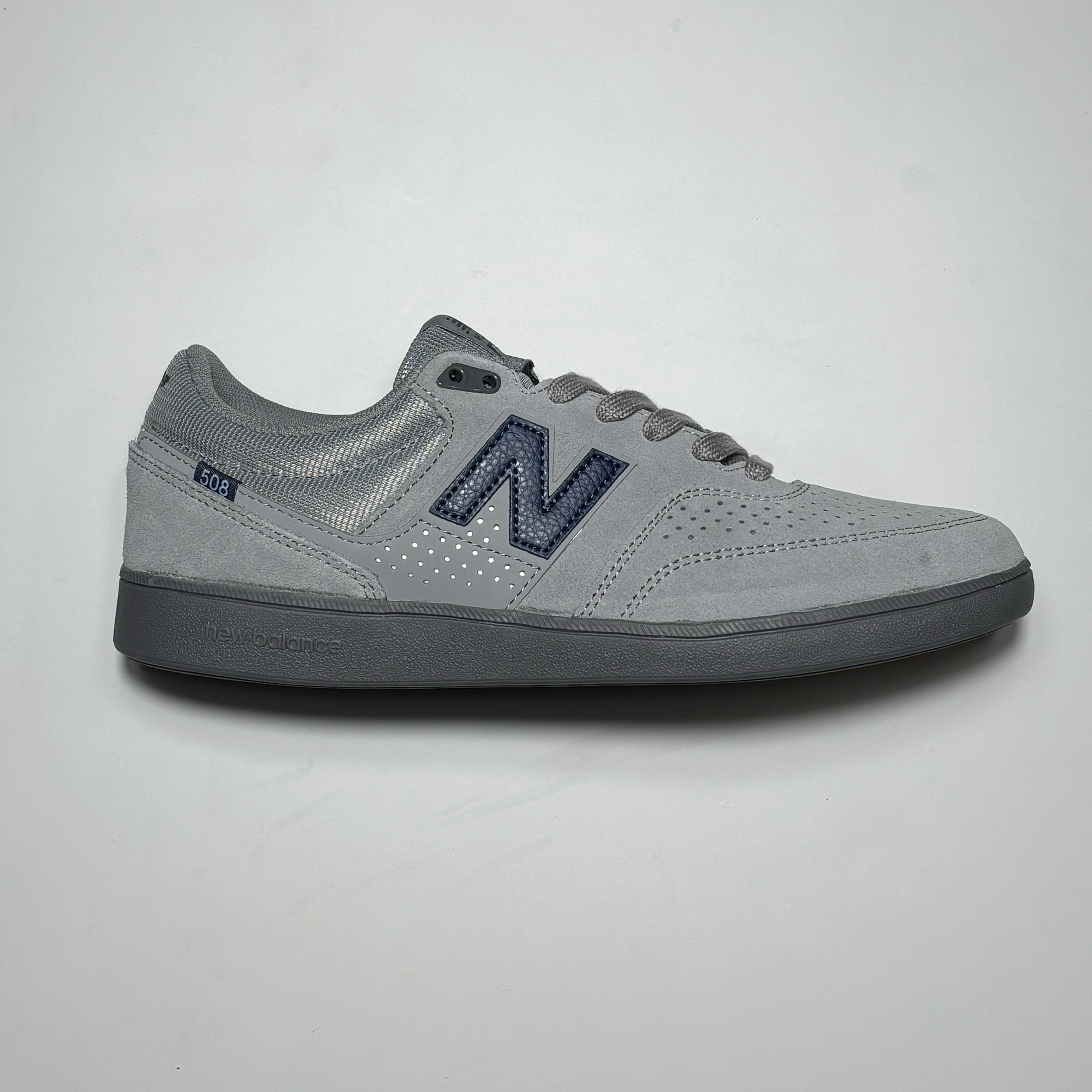 Side image of right shoe.
Grey suede with blue N branding and grey midsole.