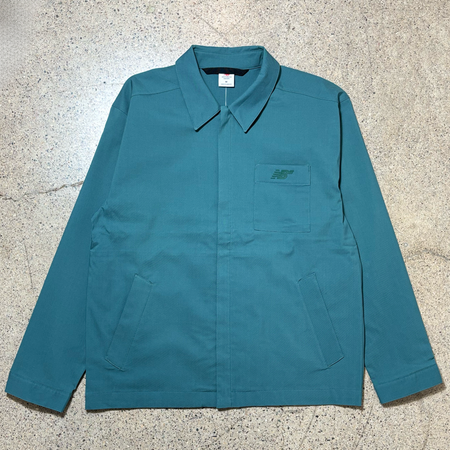 Full image of spruce green colored twill coaches style jacket.