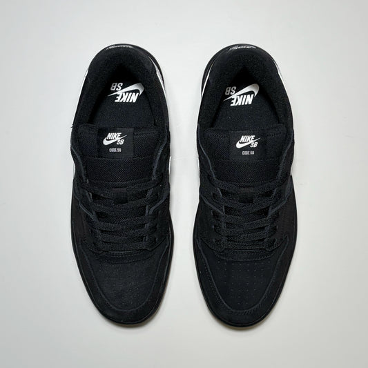 A pair of black Nike SB Code 58 sneakers with white logo details, shown from a top-down view on a light gray background.