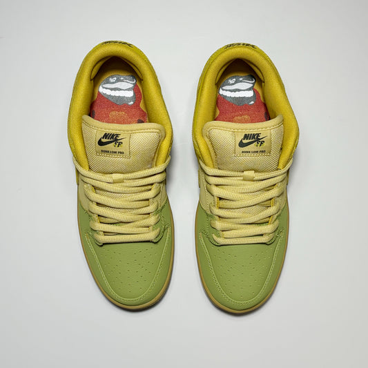 A pair of Nike SB Dunk Low Pro sneakers in olive green and yellow, shown from a top-down view on a light gray background.