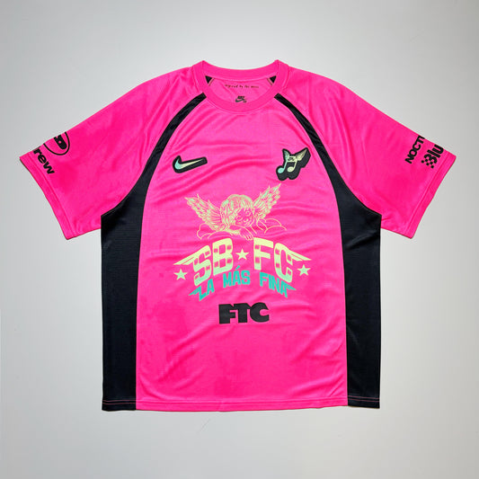 Full front image, Nike SB FC club 58 hyper pink jersey. Art printed on front and sleeves with embroidered patches on chest.