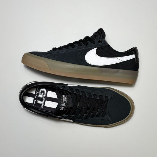Pair of Nike SB Grant Taylor Blazer Low Shoes. Displayed 1 on its side and the other toe down on gray background