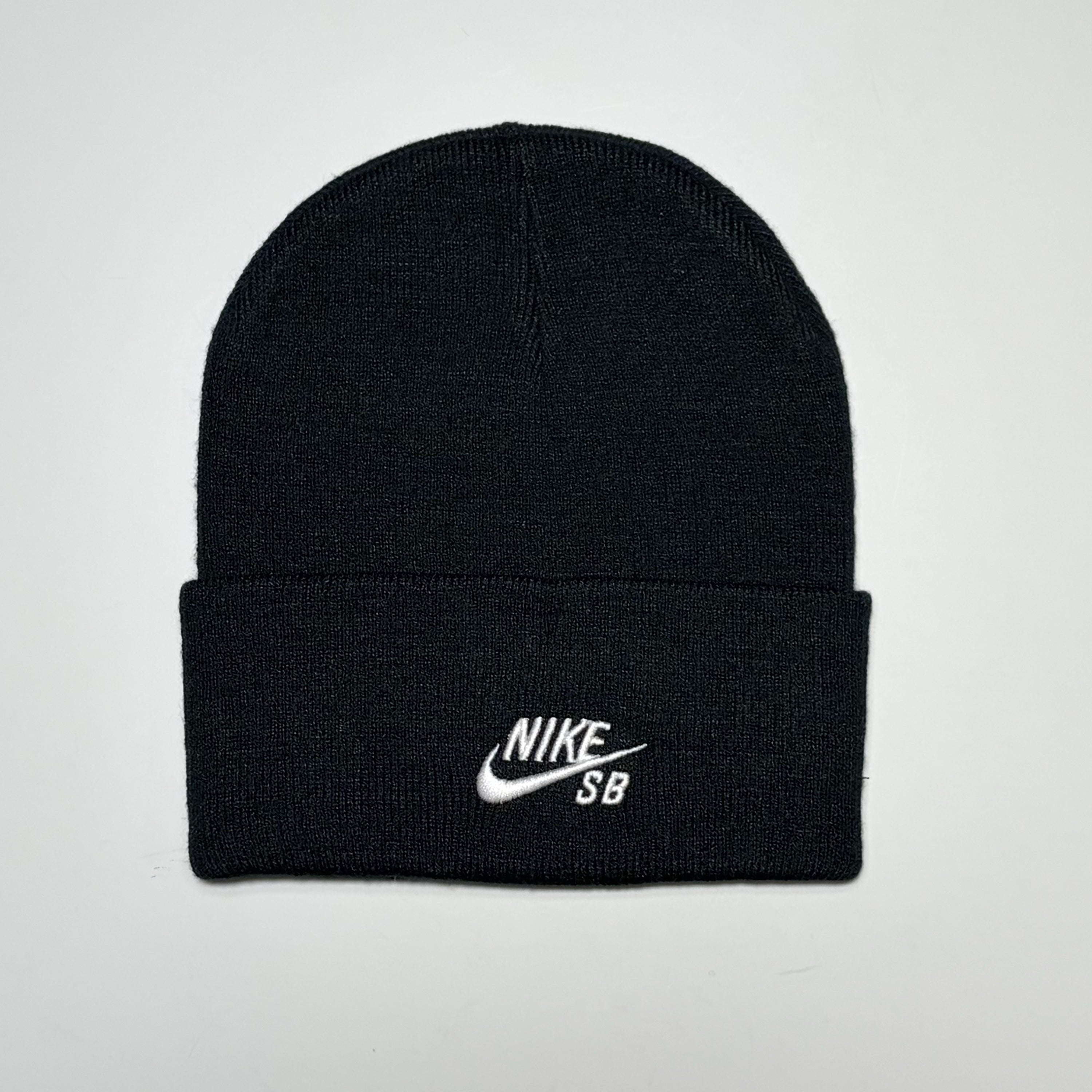 Full front image of Nike SB Peak Beanie in black with white embroidered logo