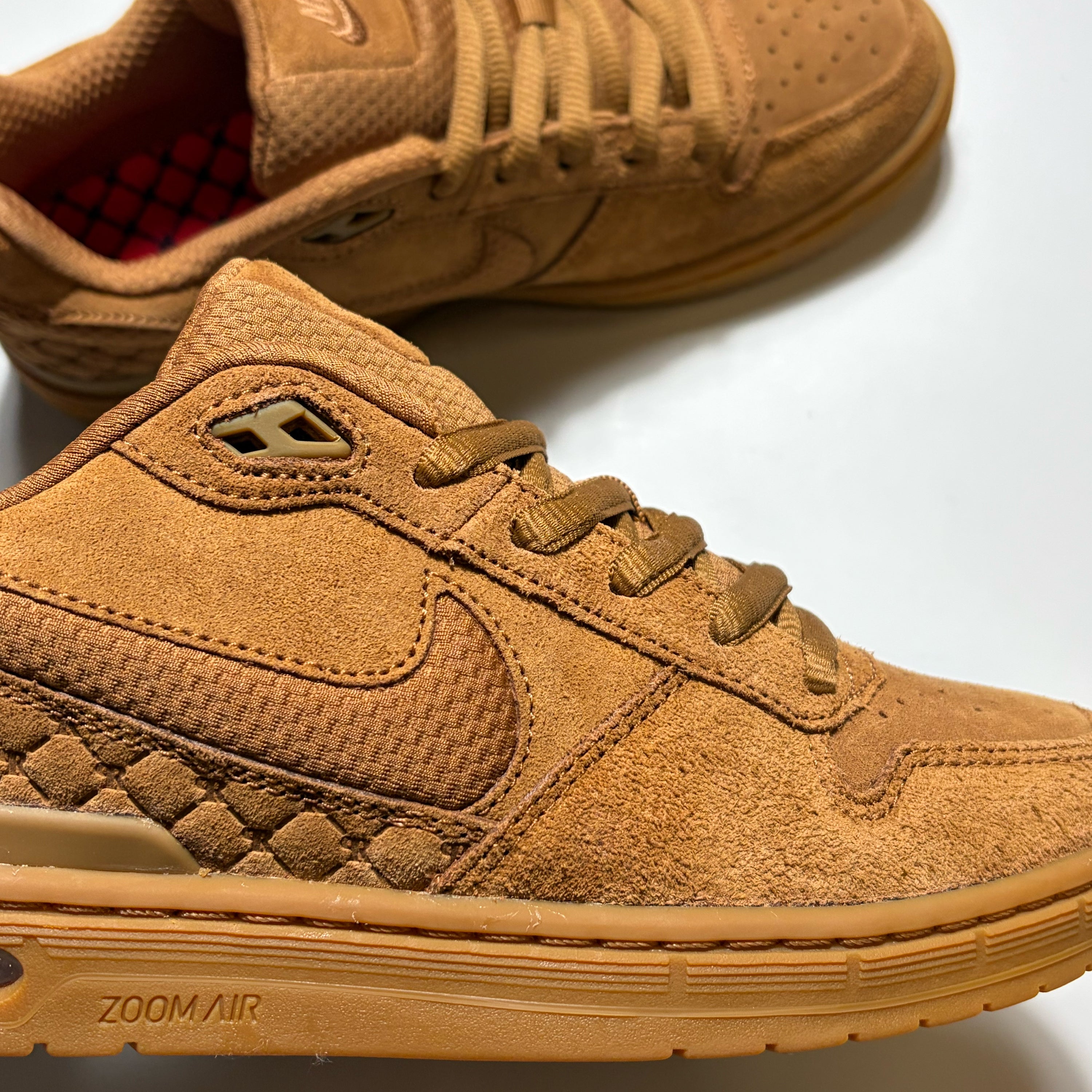 A pair of Nike SB Prod 1 Low sneakers in a monochromatic tan and brown suede and mesh upper, featuring a quilted diamond pattern on the heel, matching laces, and a gum sole with 'ZOOM AIR' text.