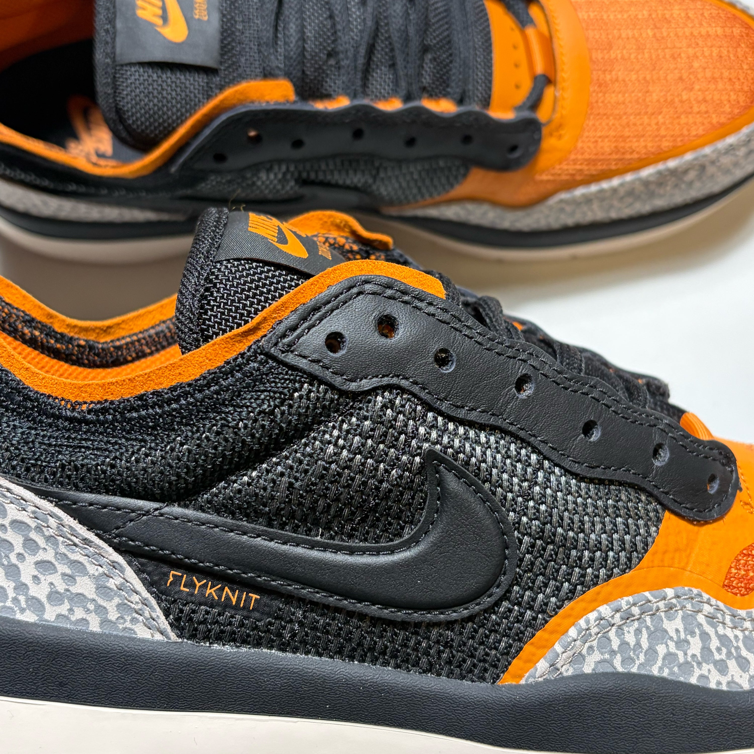 Close detail of Flyknit construction with black Nike SB swoosh.