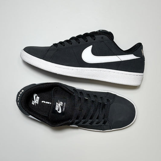 A pair of Nike SB Zoom Tennis Classic Low sneakers in black and white, displayed from side and top-down angles on a light gray background.