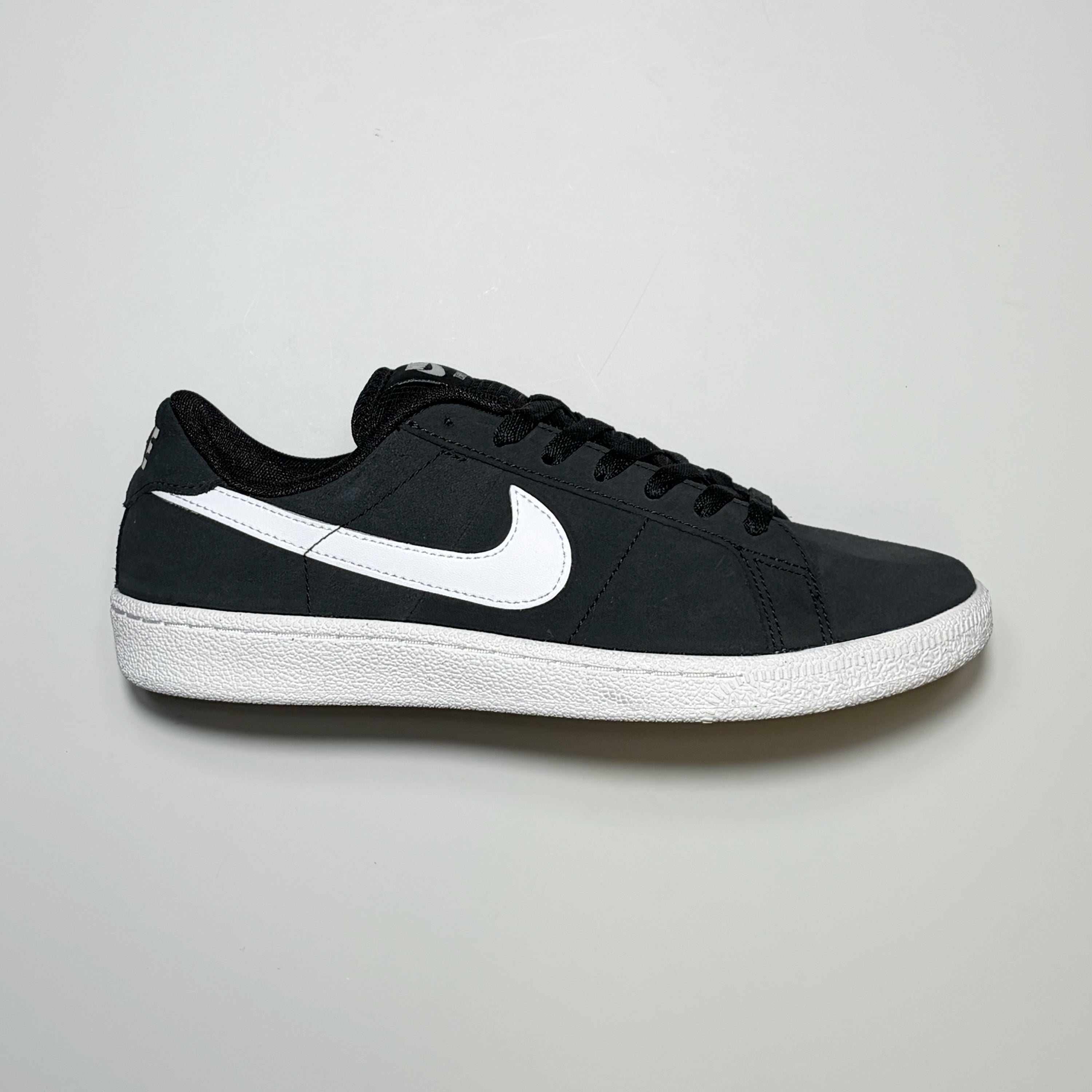 Right side image, Nike SB Zoom Tennis Classic in black suede with white swoosh.