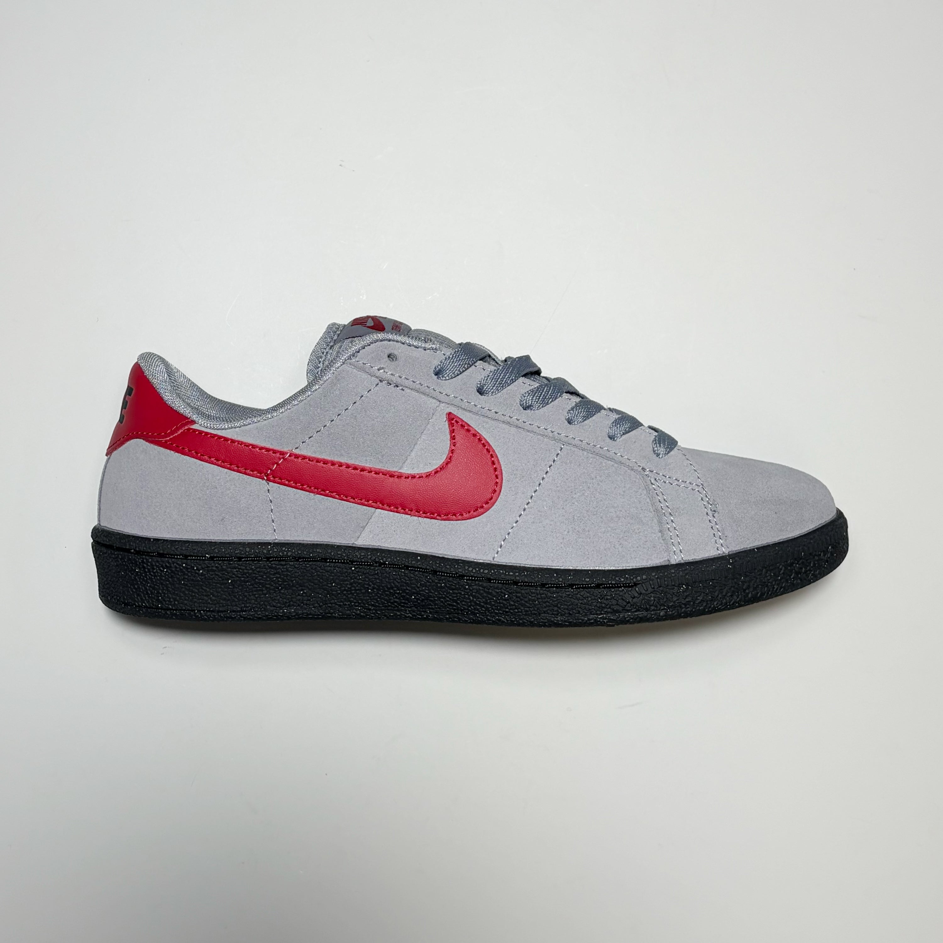 Right side image, Nike SB Zoom Tennis Classic in stealth grey with red swoosh.