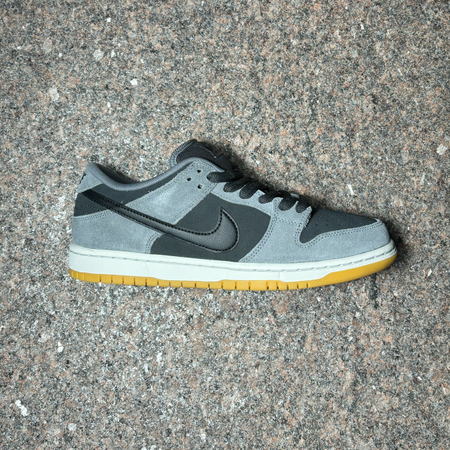 Side profile of right shoe. Grey suede with black toe, mid panel and swoosh. 