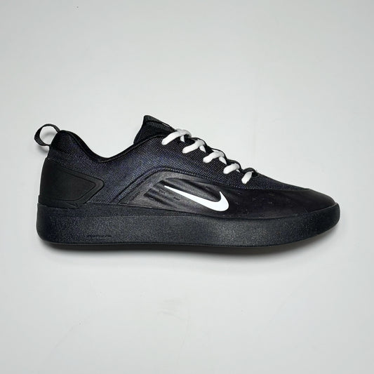 Side image of right shoe. Black nubuck with nylon and outsole. White swoosh logo.