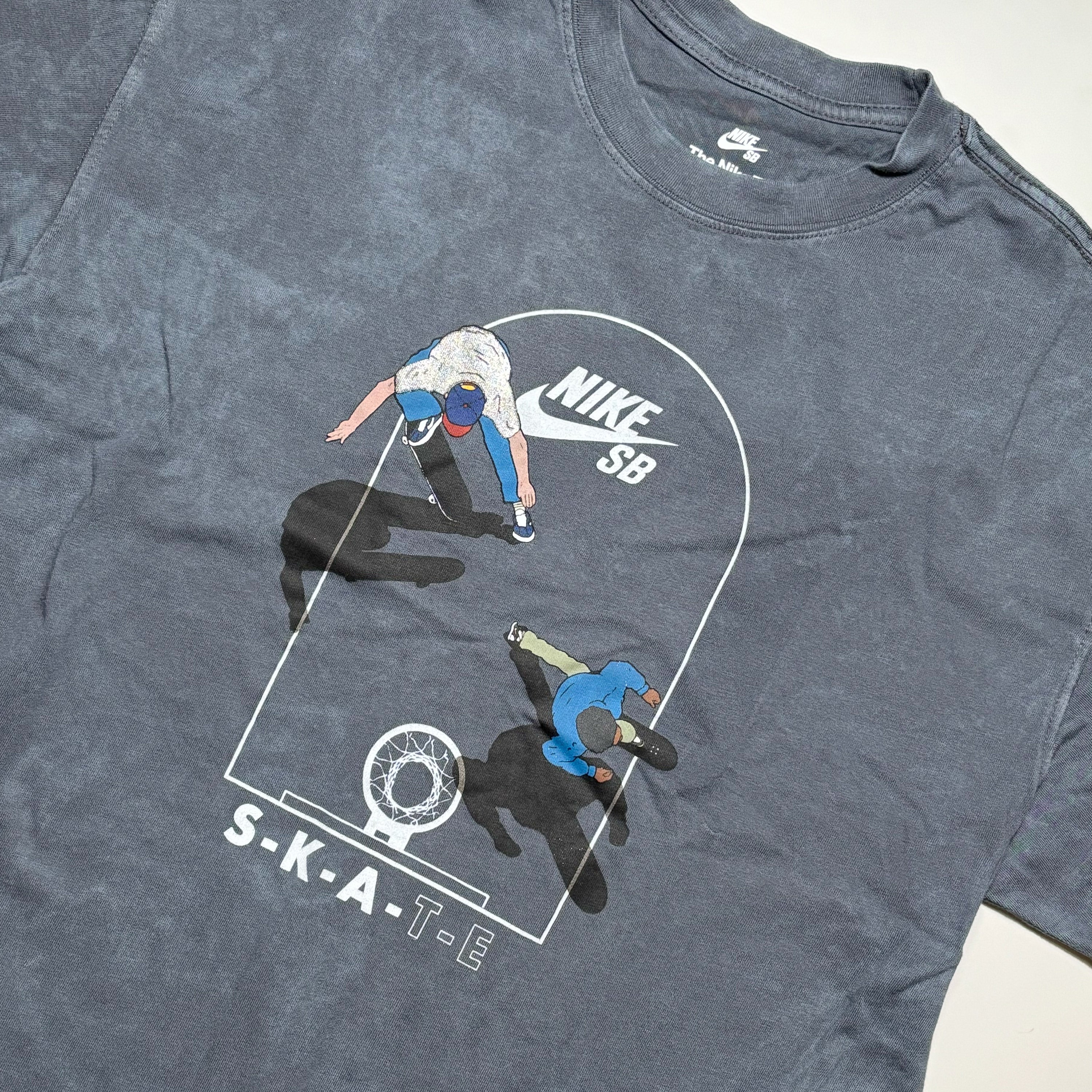 Gray t-shirt with Nike SB graphic of a skateboarder and 'S-K-A-T-E' text.