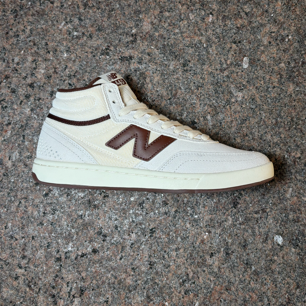 Side profile of right shoe. All white suede with brown 