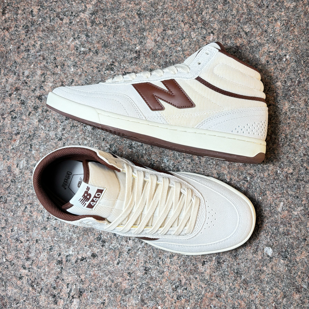 Toe down view with side profile.
Brown trim and outsole accents, NB# branding on tongue. 