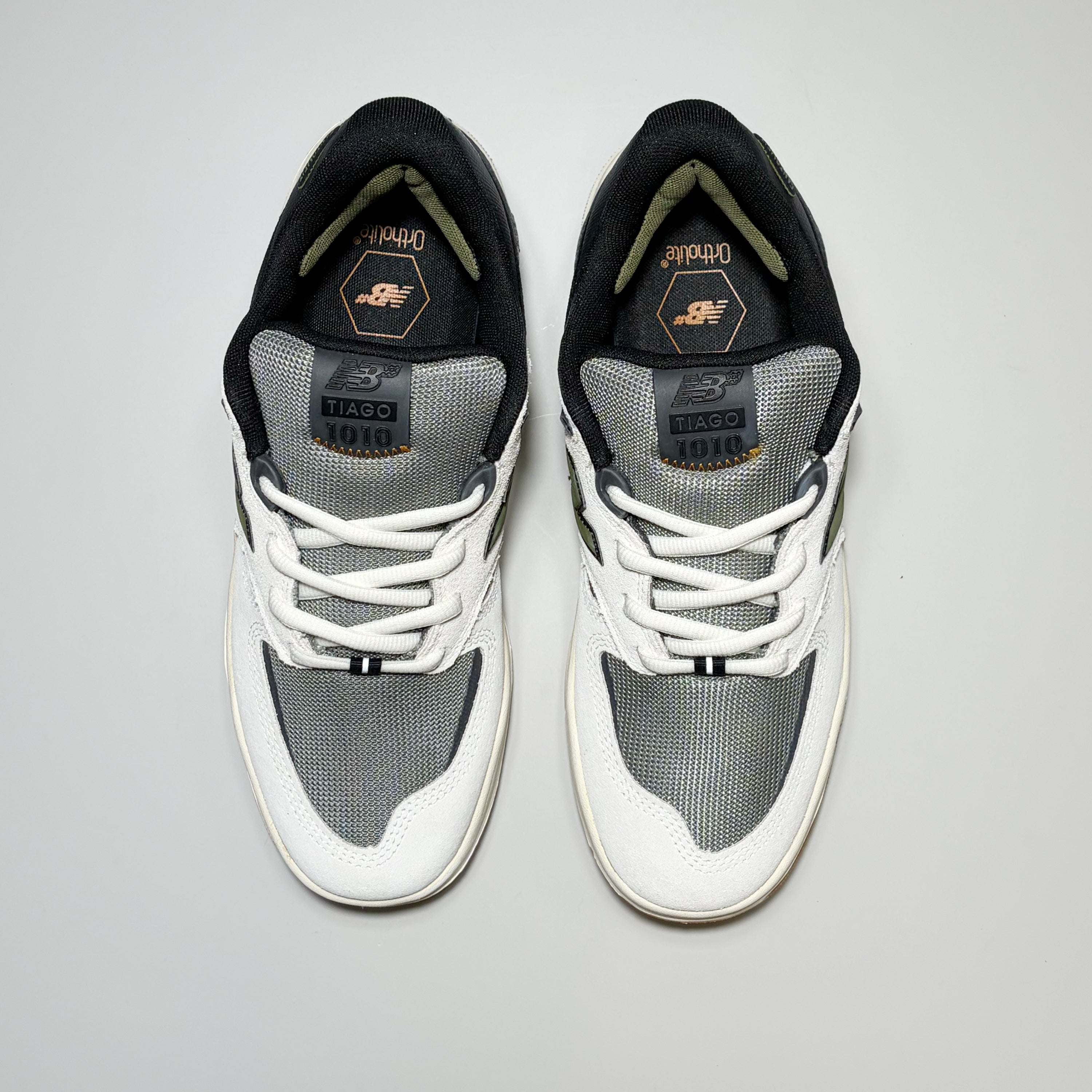 Toe down view of New Balance Numeric Tiago 1010 shoes. White suede toe with grey mesh toe box and tongue.