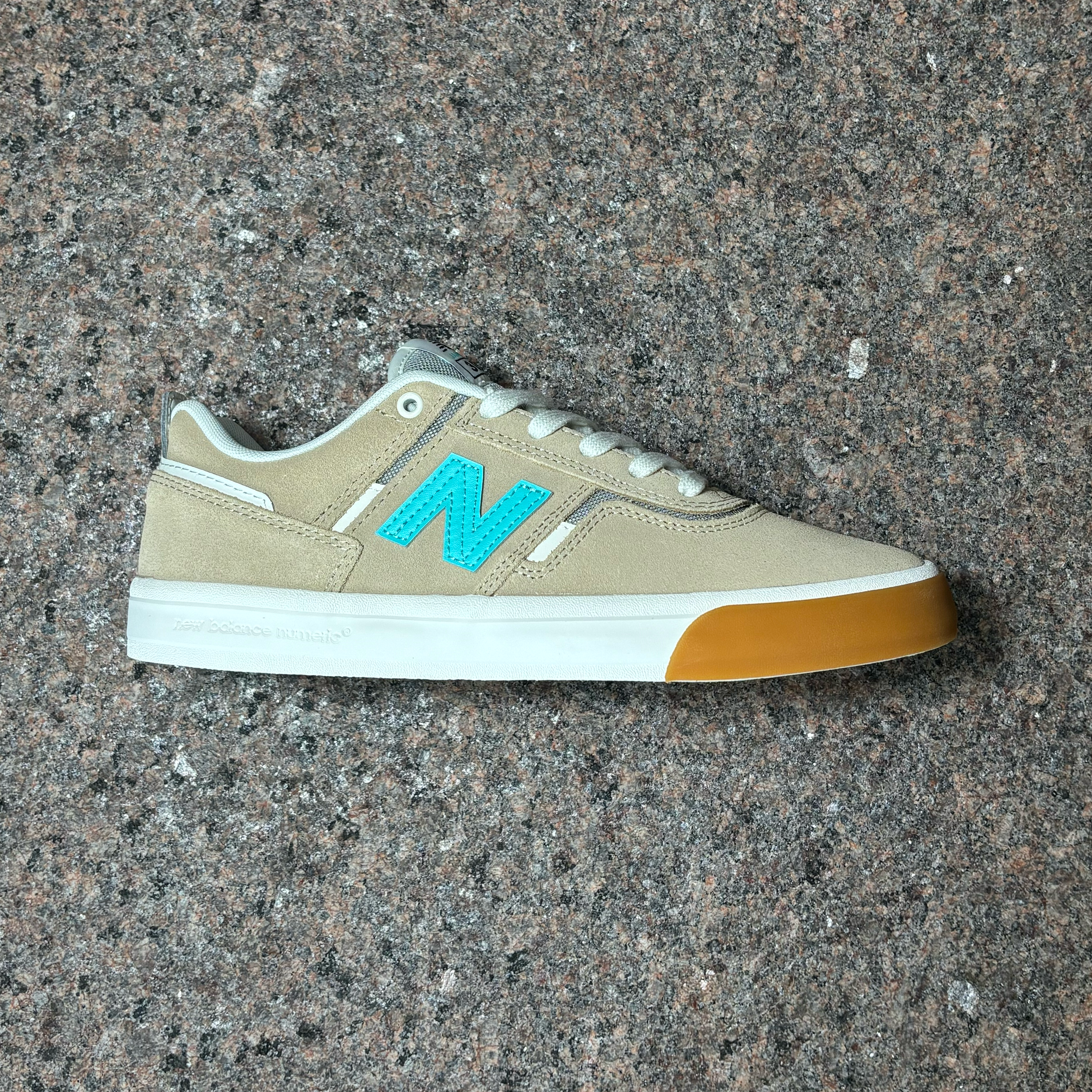 Side profile image of right shoe.
Beige suede with teal 