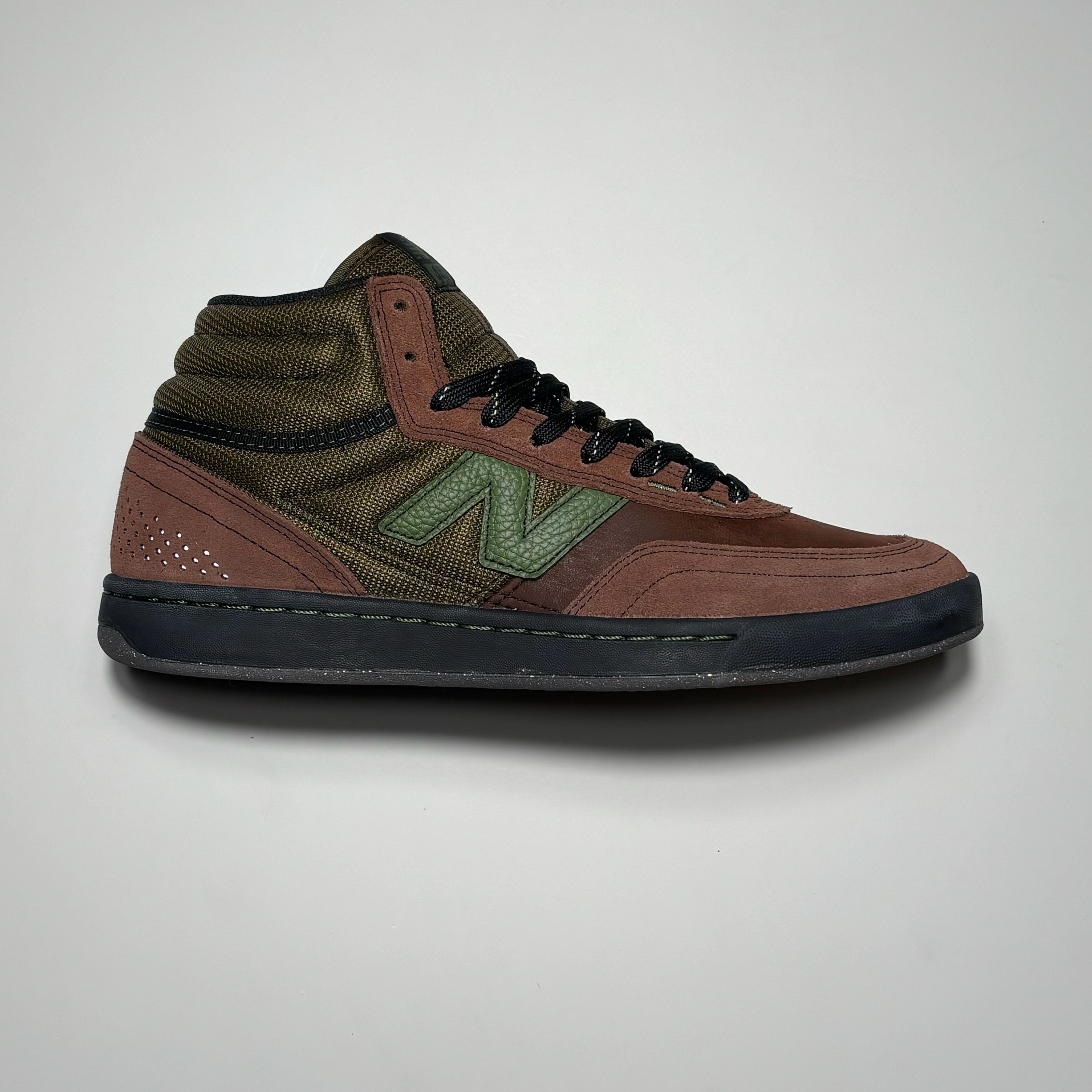 Side image of right shoe. Brown suede with olive panel.