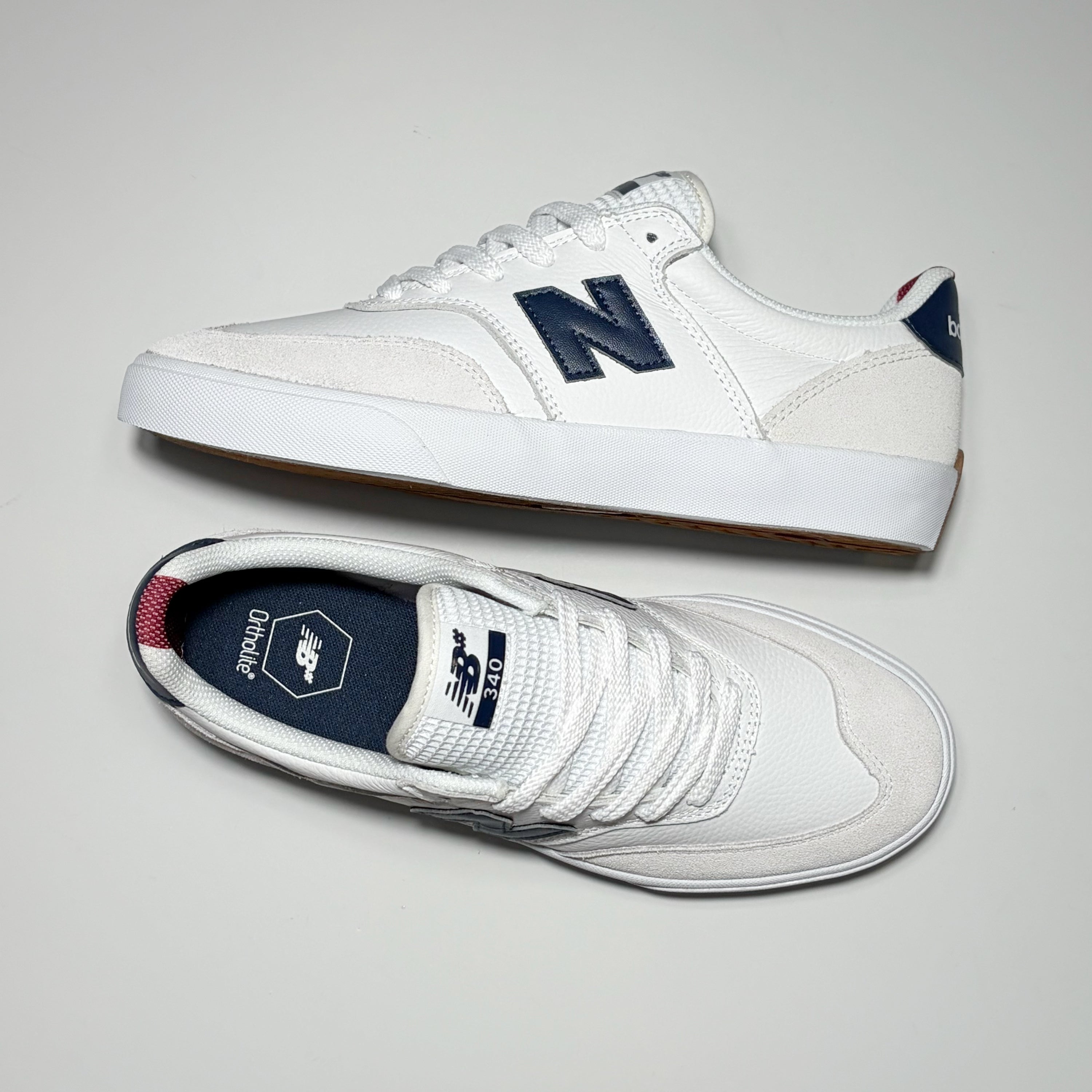 Pair of Numeric 340 shoes in white with navy detail hits on tongue.