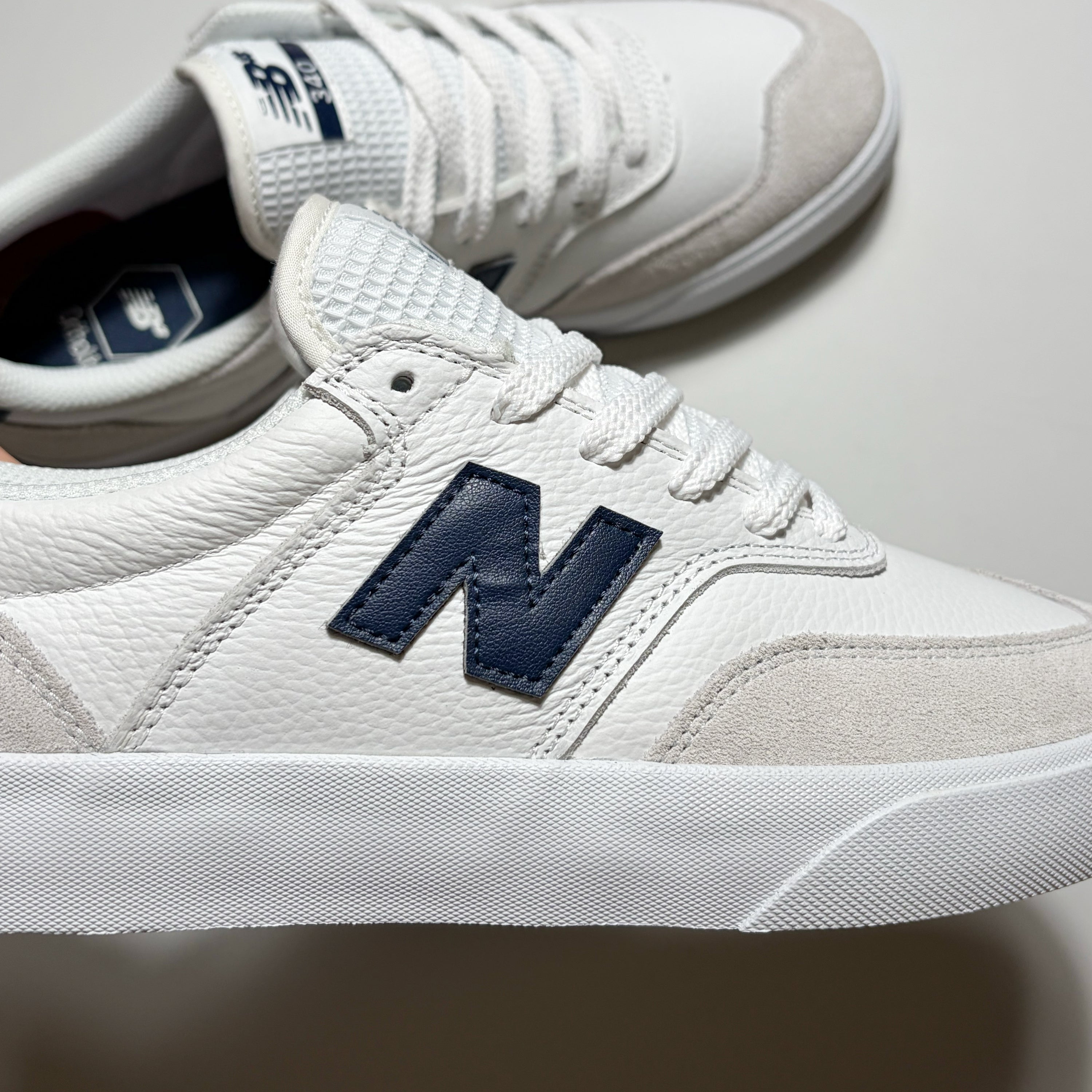 Close detail of navy "N" branding on mid-panel.