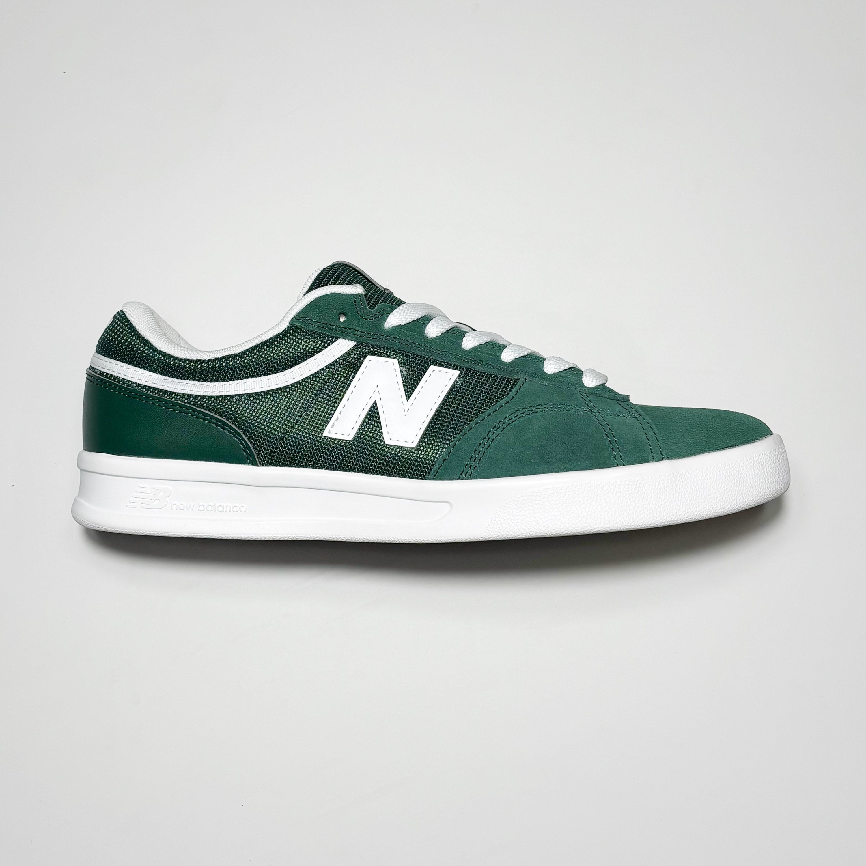 Side image of right shoe. Green suede with white N branding on mid-panel.