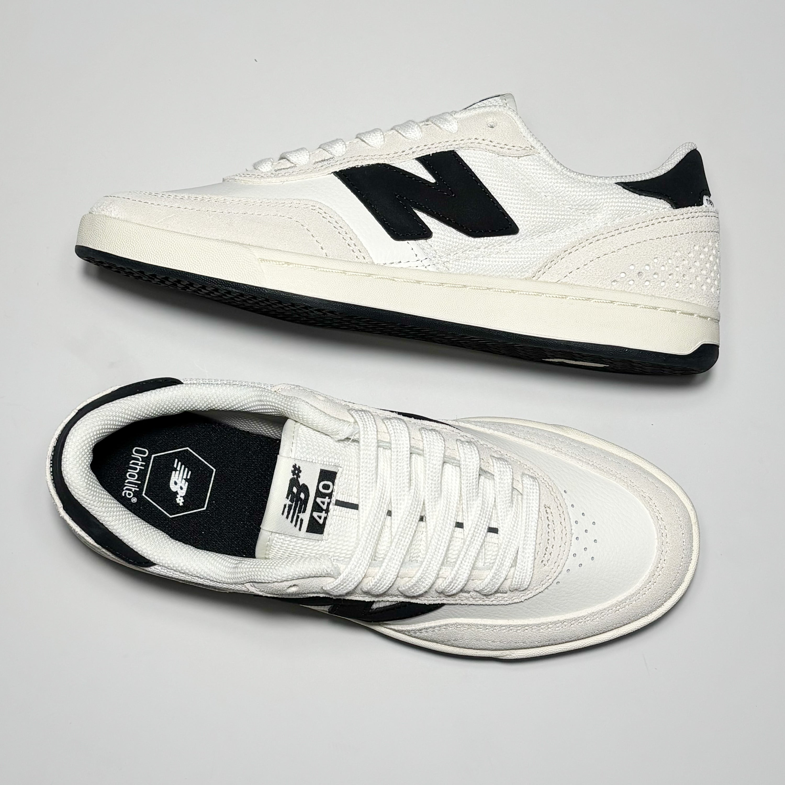 Toe down view side profile. NB branded woven label on tongue.