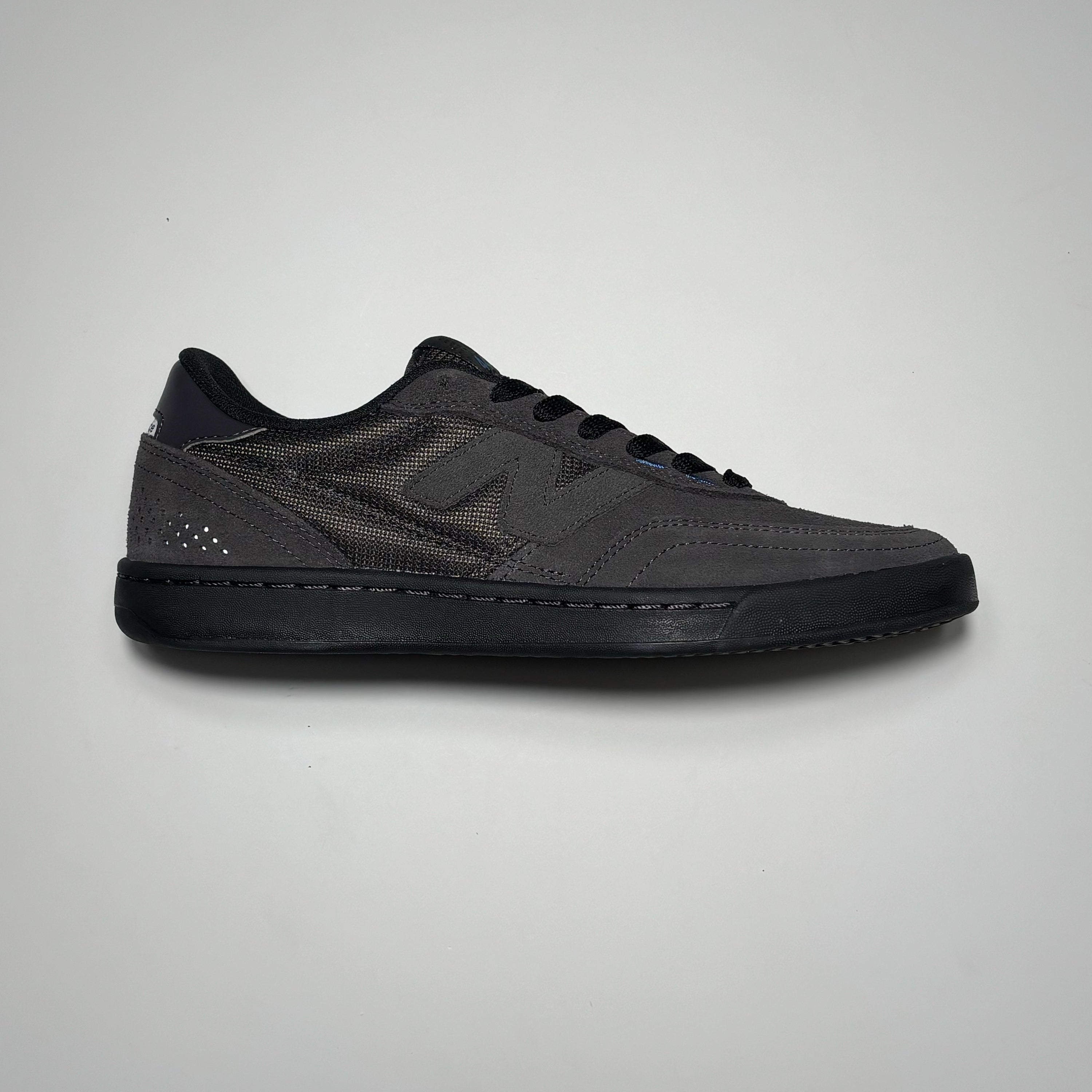 Side image of right shoe. Black cement suede with black outsole.