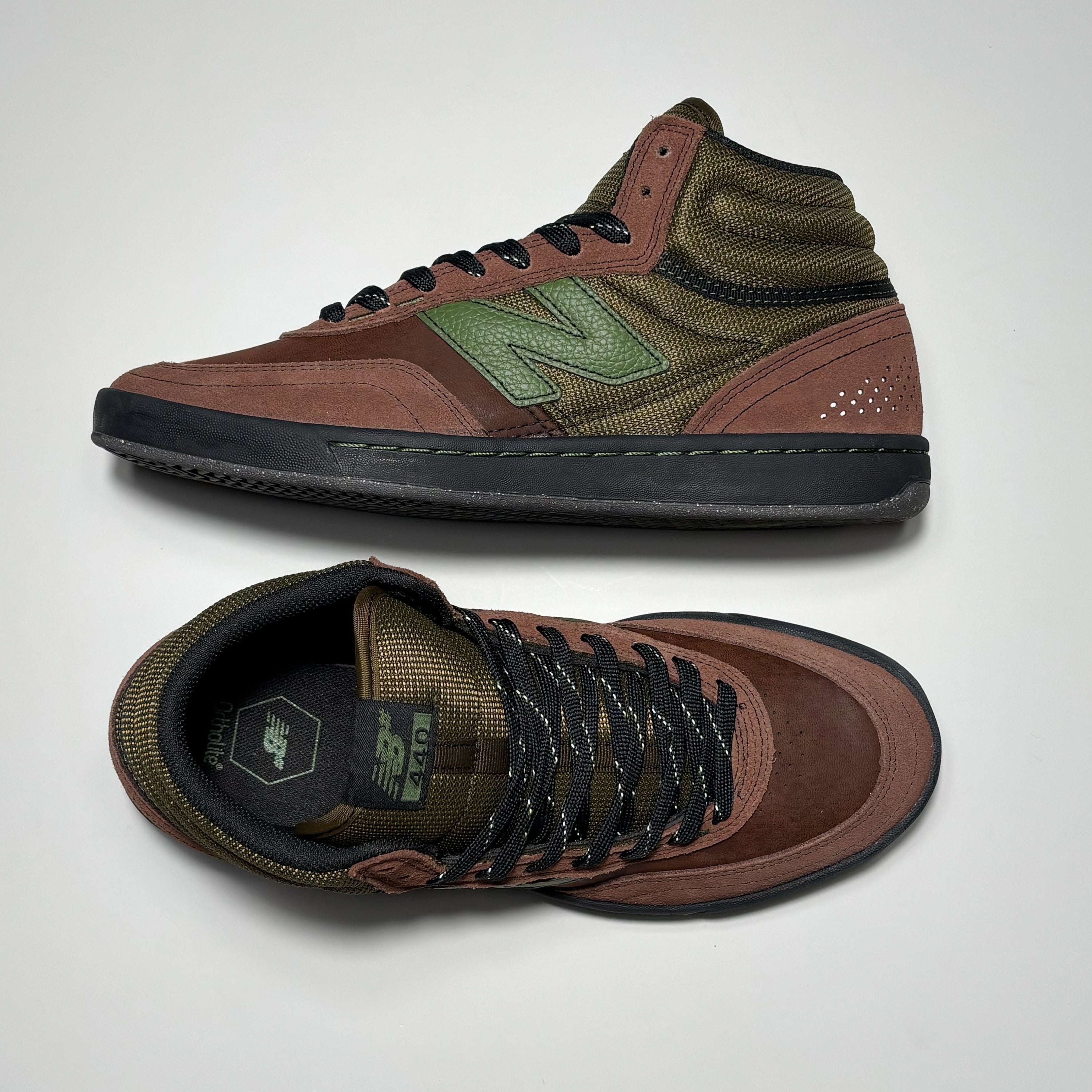 Toe down view with side profile. 
NB# woven label on tongue.