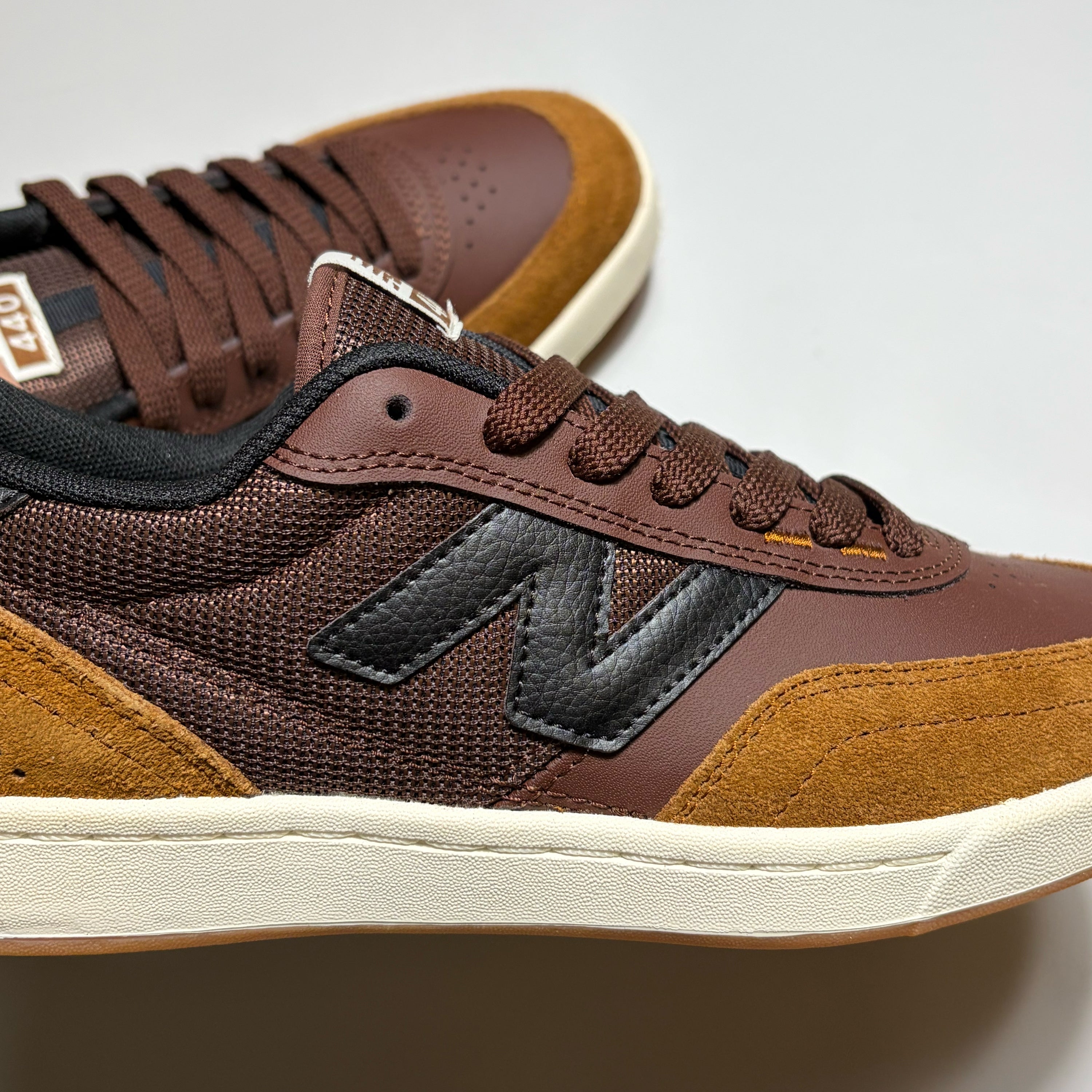 Close detail of black "N" branding on mid-panel