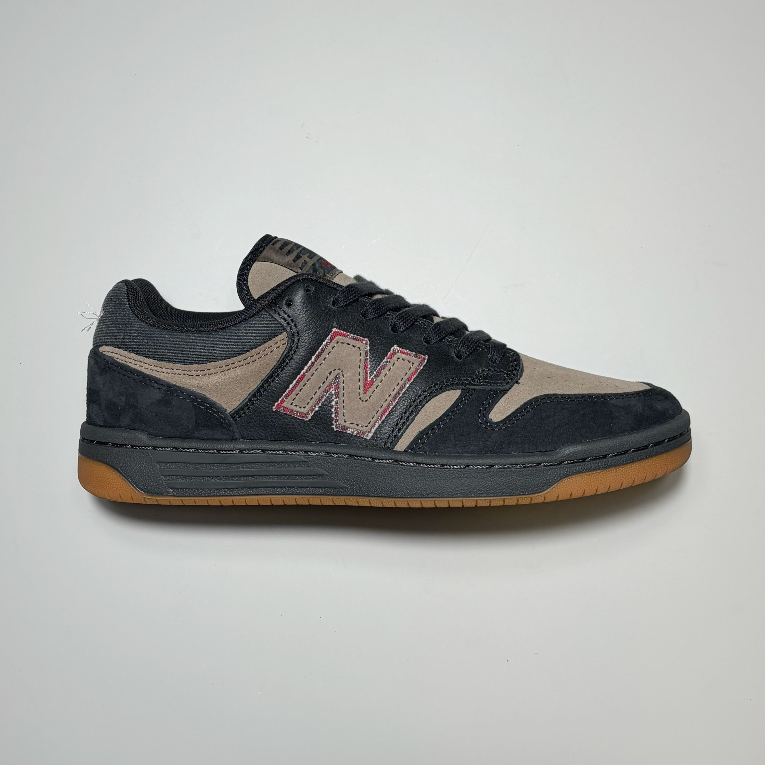 Side image of right shoe, black/brown New balance NM480 shoe with brown N on side panel.
