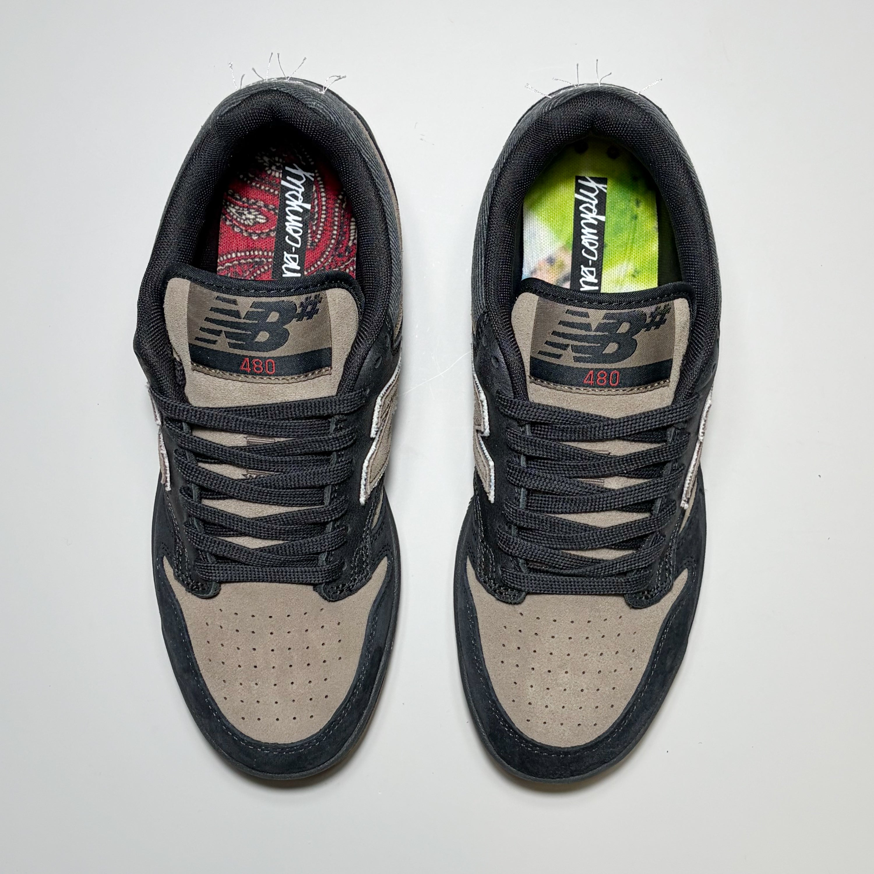 Toe down view of both New Balance NM480 shoes. NB# branding on tongue.