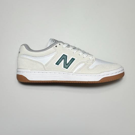 Side image of right shoe. White suede with green N on mid panel
