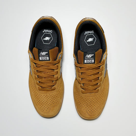 Toe down view of New Balance Numeric shoes in brown. 