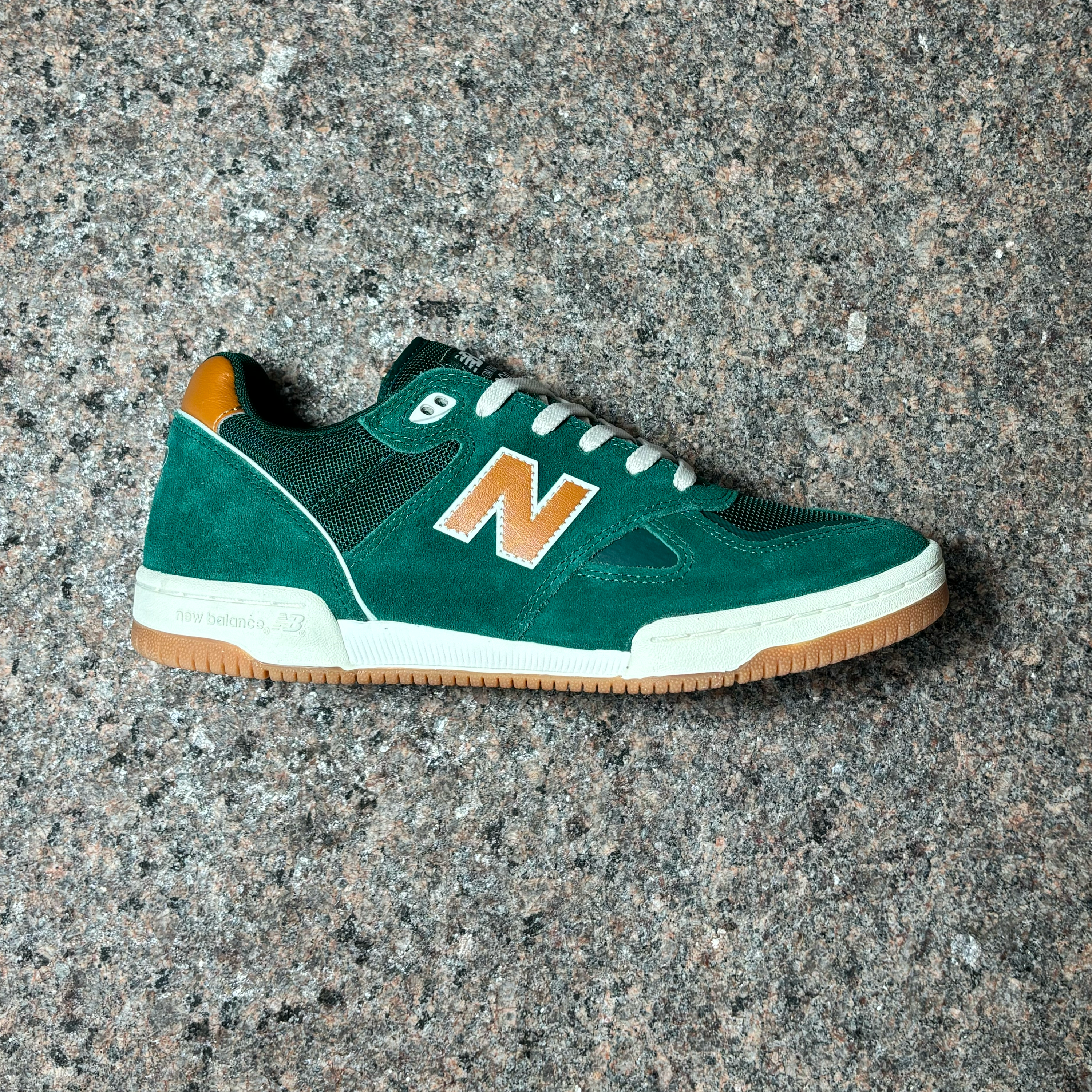 Side profile of right shoe.
Green suede panels with orange 