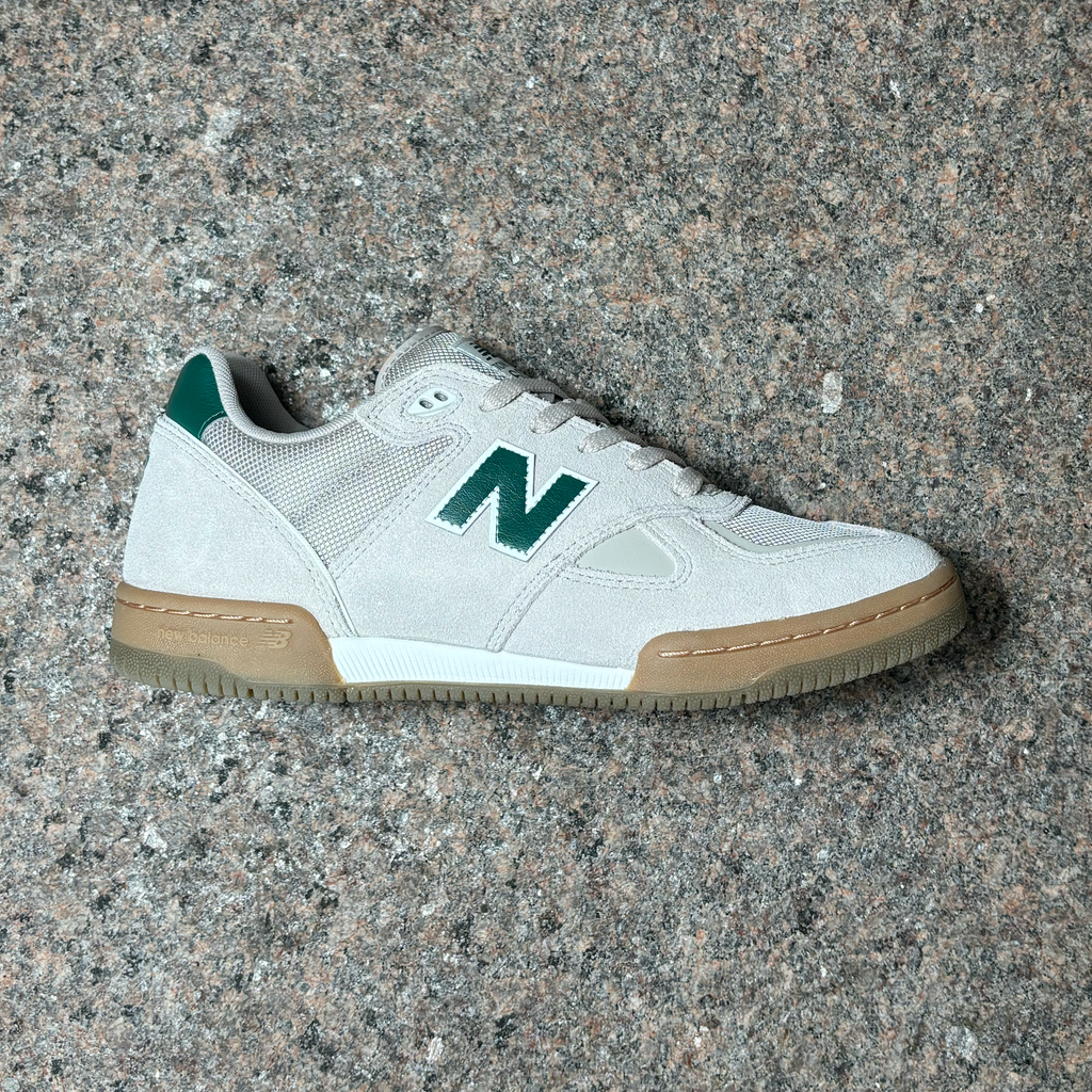 Side profile view of right shoe.
Beige suede panels with green 