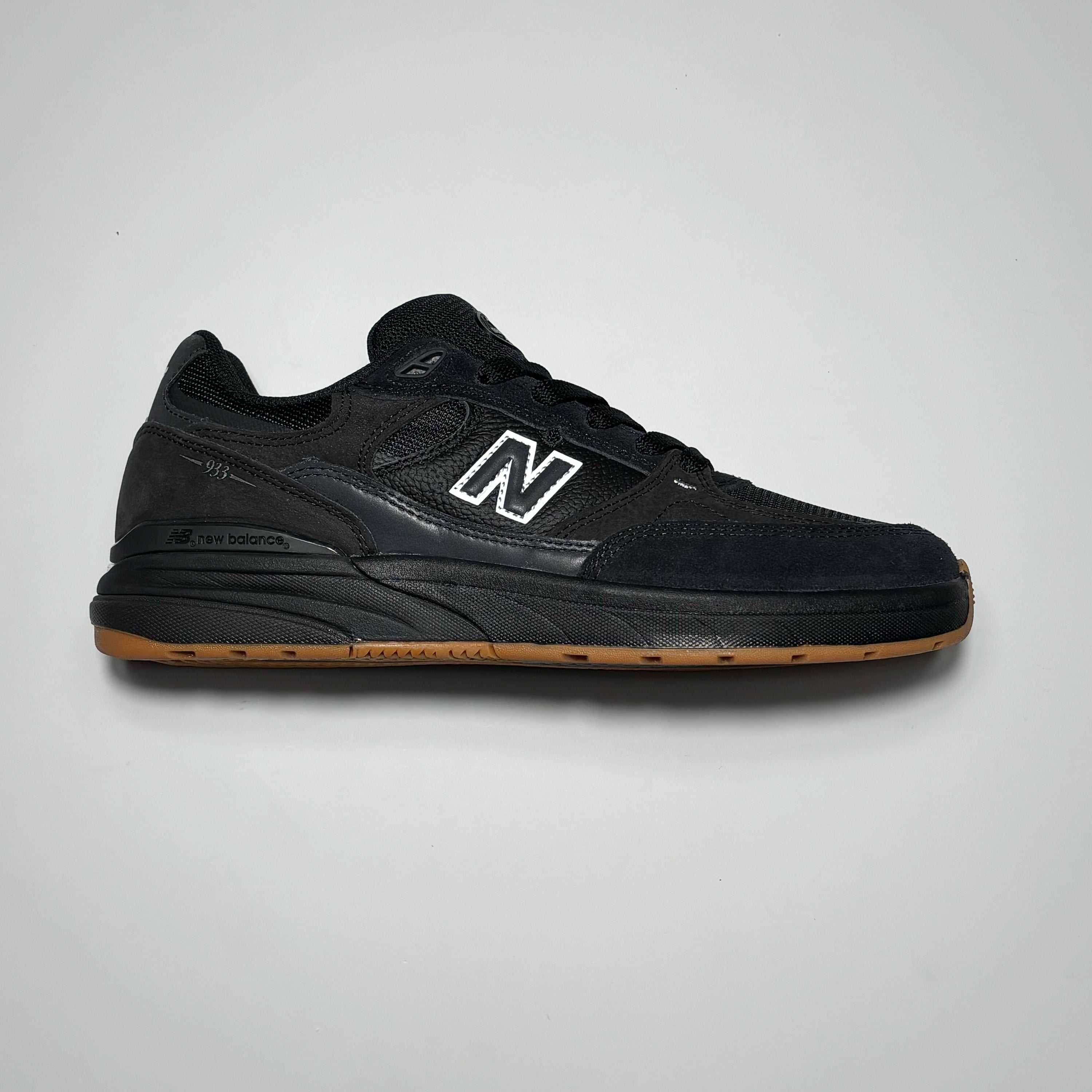 Side image of right shoe. Black on black suede with gum outsole.