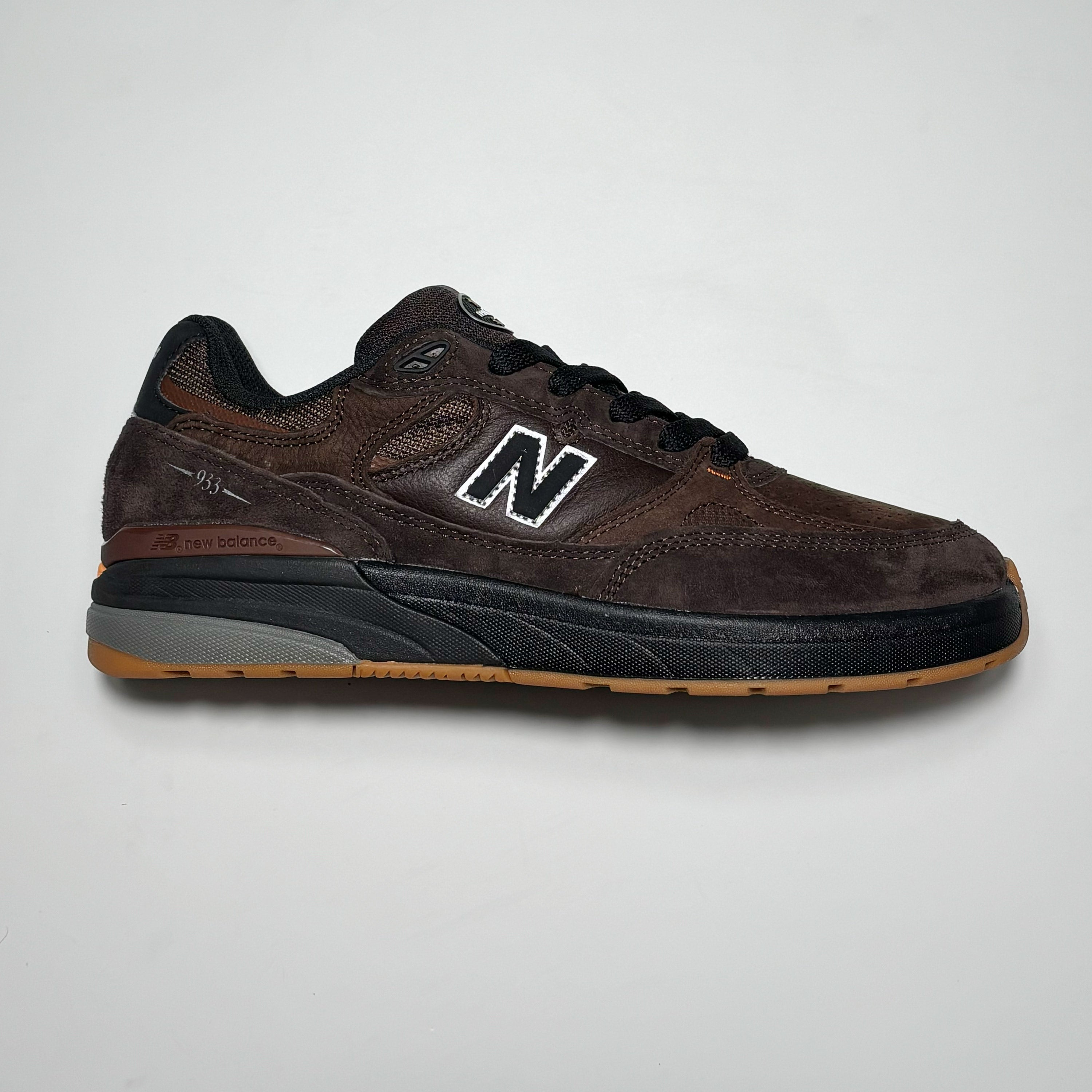 Side image of right shoe. Brown suede with black outsole and N branding.