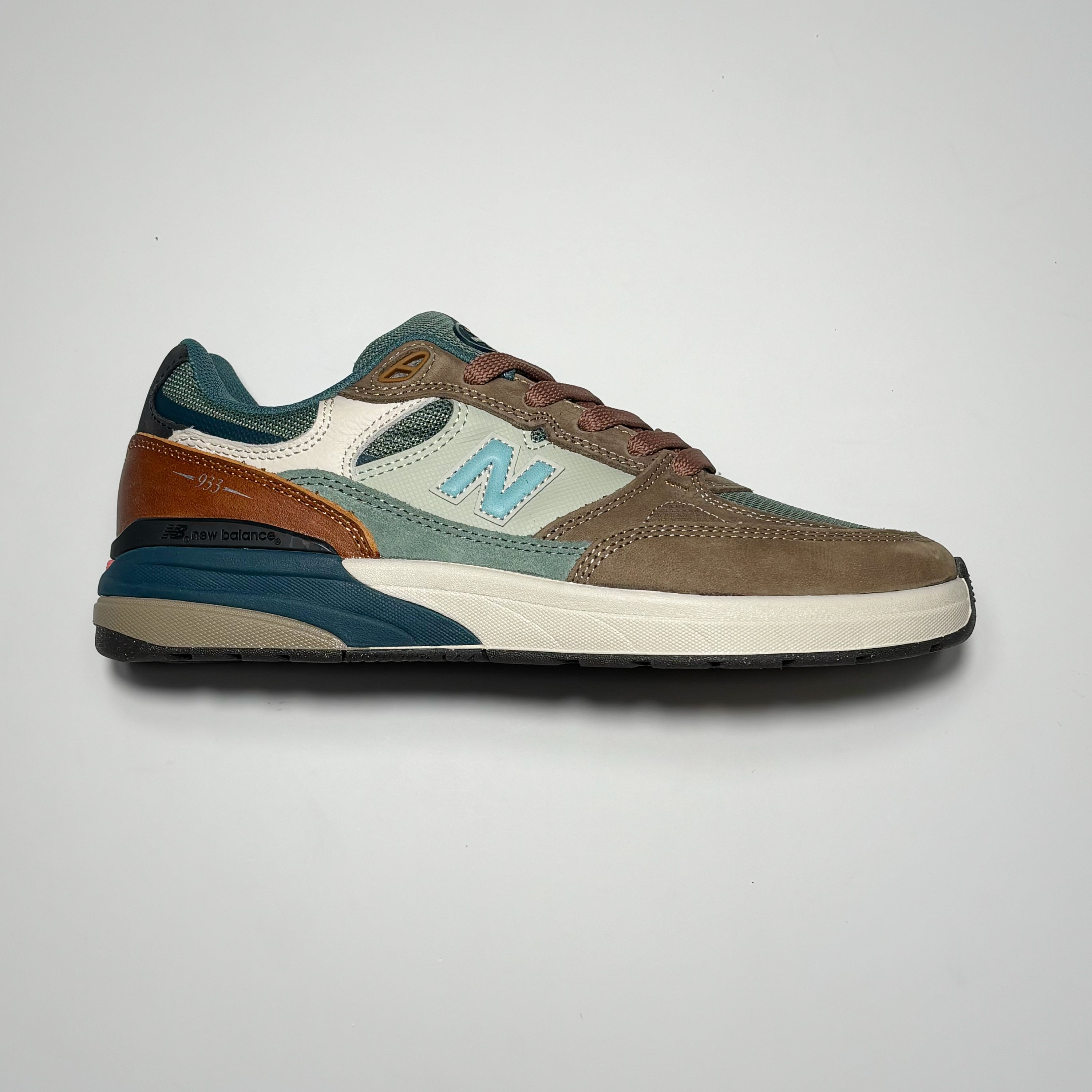 Side image of right shoe. Brown with olive and orange panels.