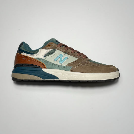 Side image of right shoe. Brown with olive and orange panels.