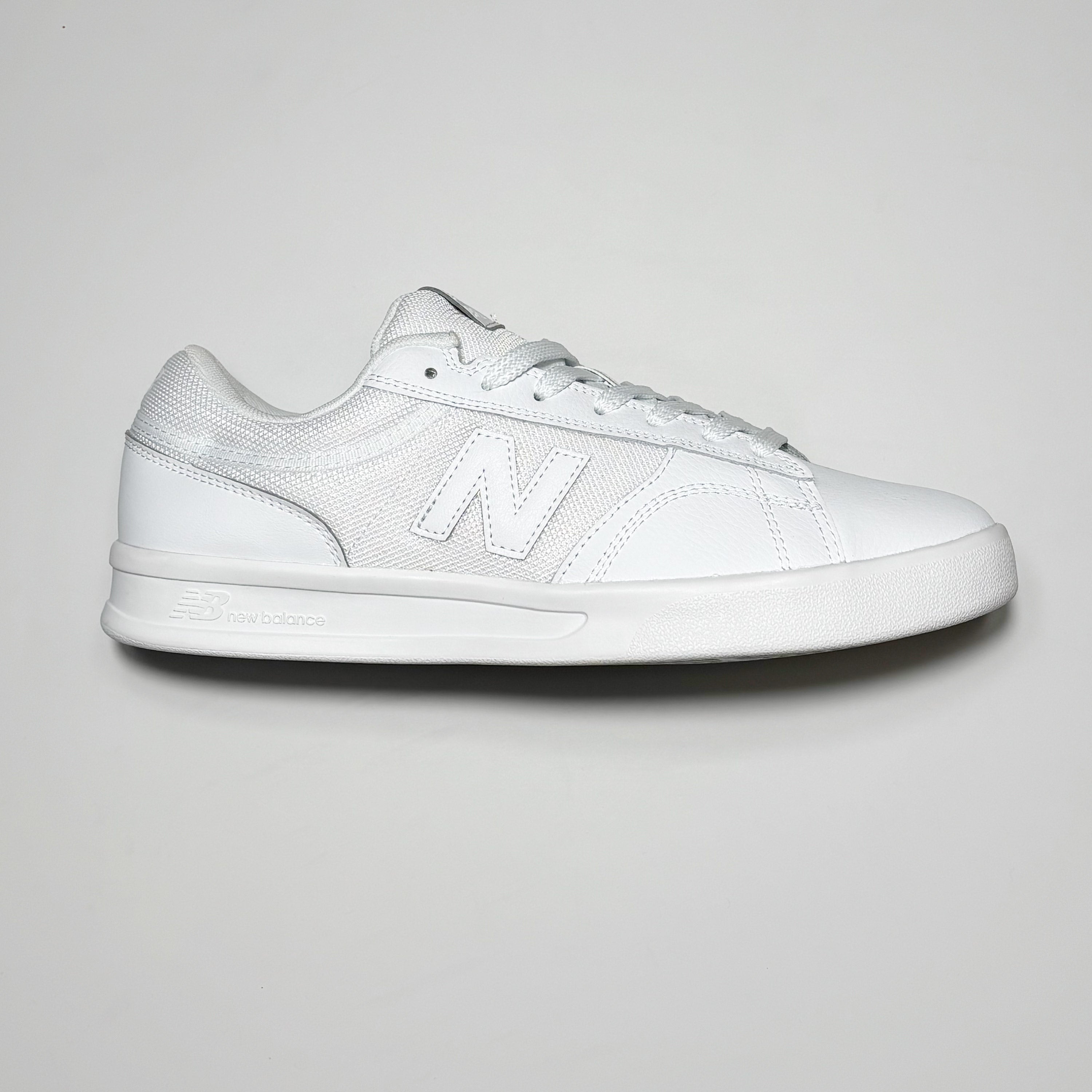 Side image of right shoe. White leather with tonal N branding on mid-panel