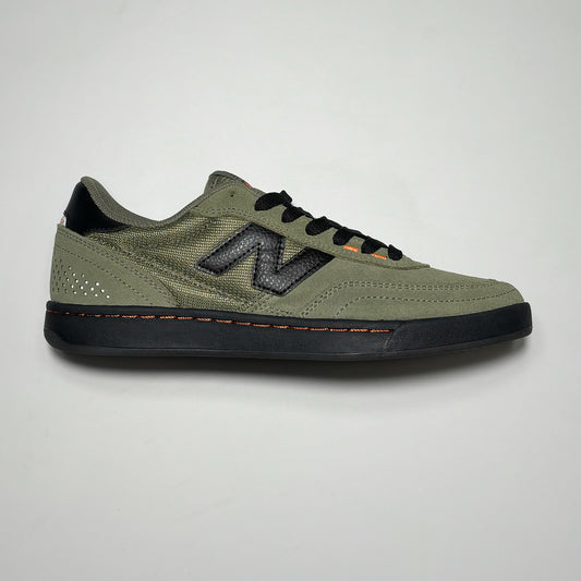 Side image of right shoe. Olive suede with black outsole. Black N branding on mid-panel.
