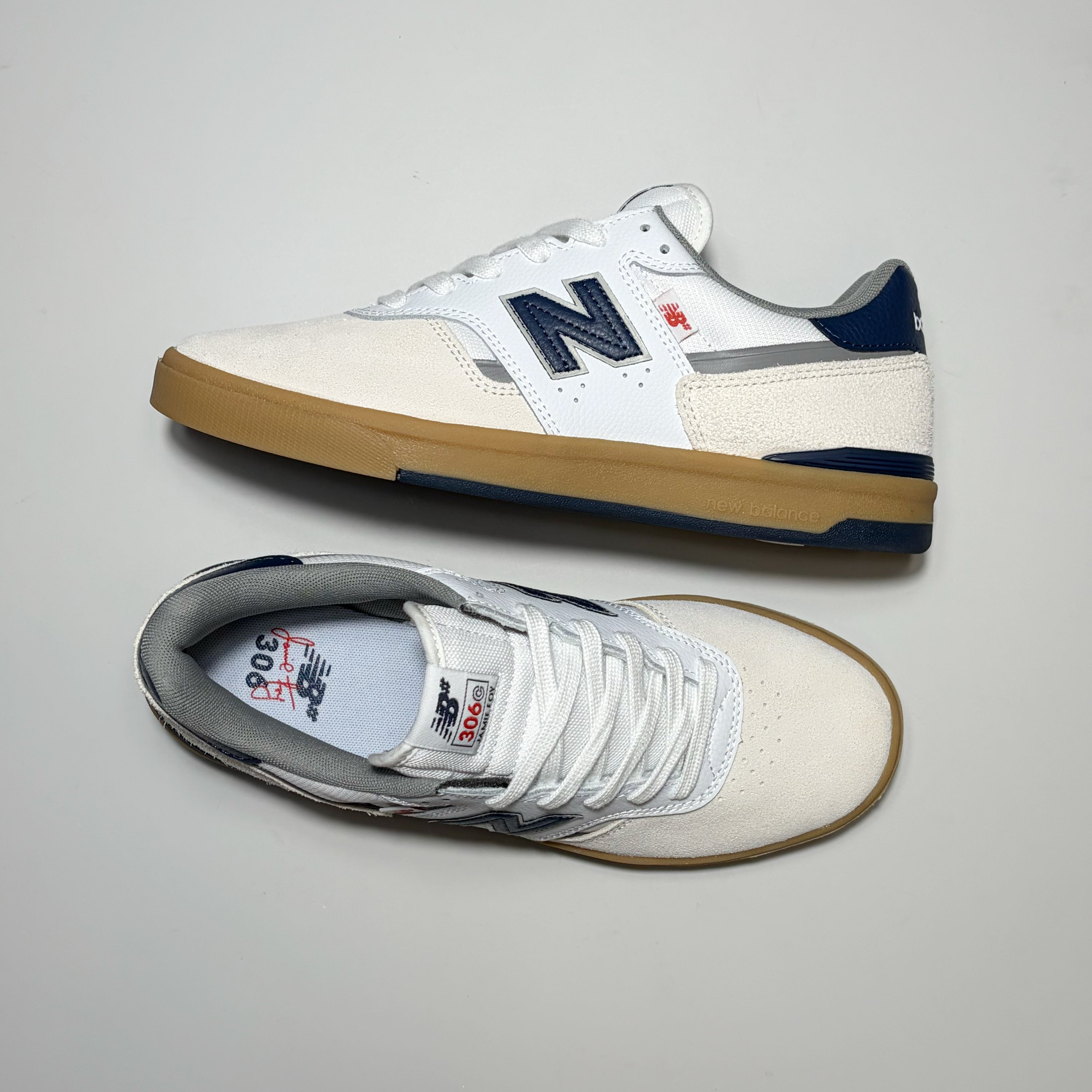 Pair of New Balance Numeric NM306C Jamie Foy shoes on grey background.