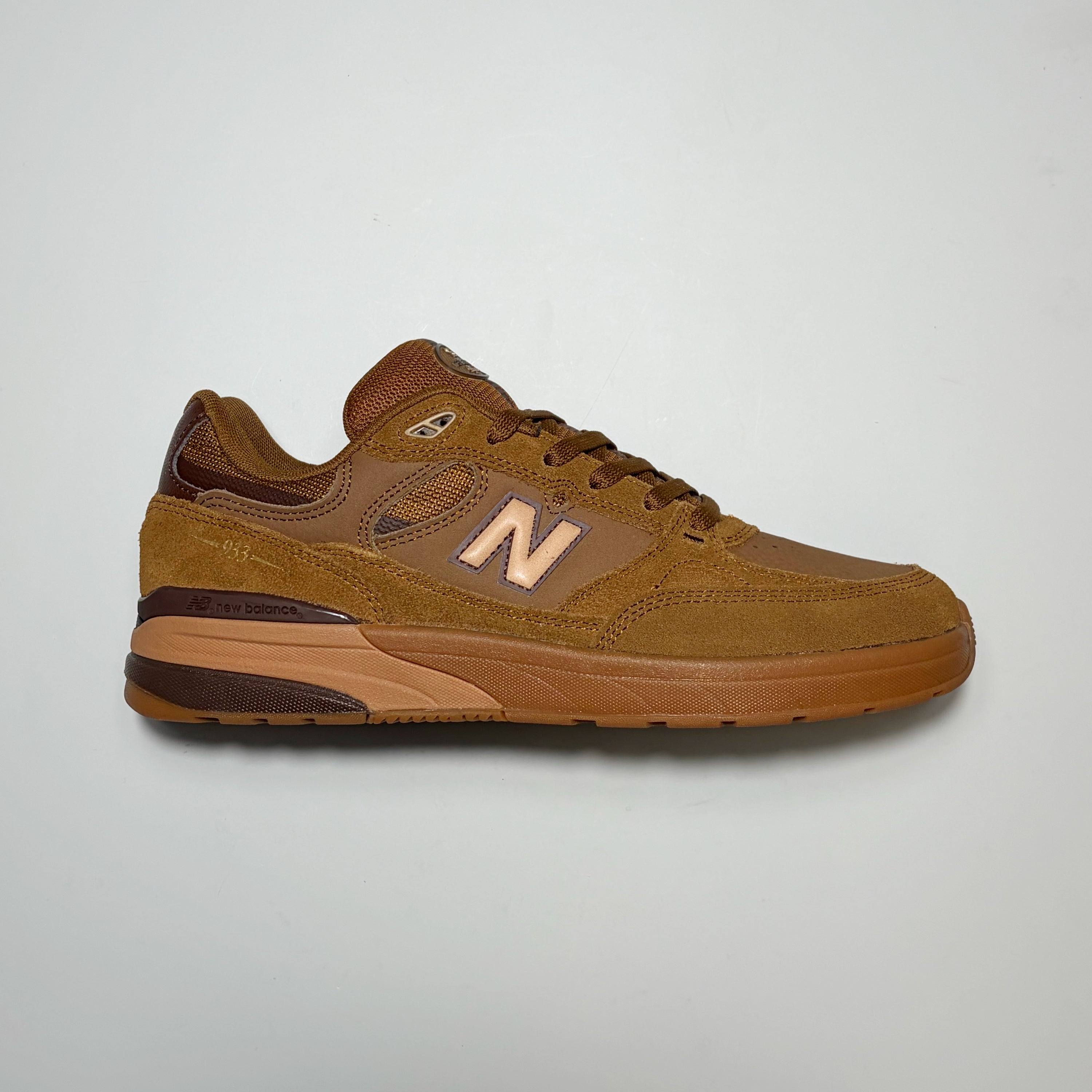 Right side image, New Balance Numeric NM933 Andrew Reynolds sneaker. Brown suede with tan 'N' and gum outsole.